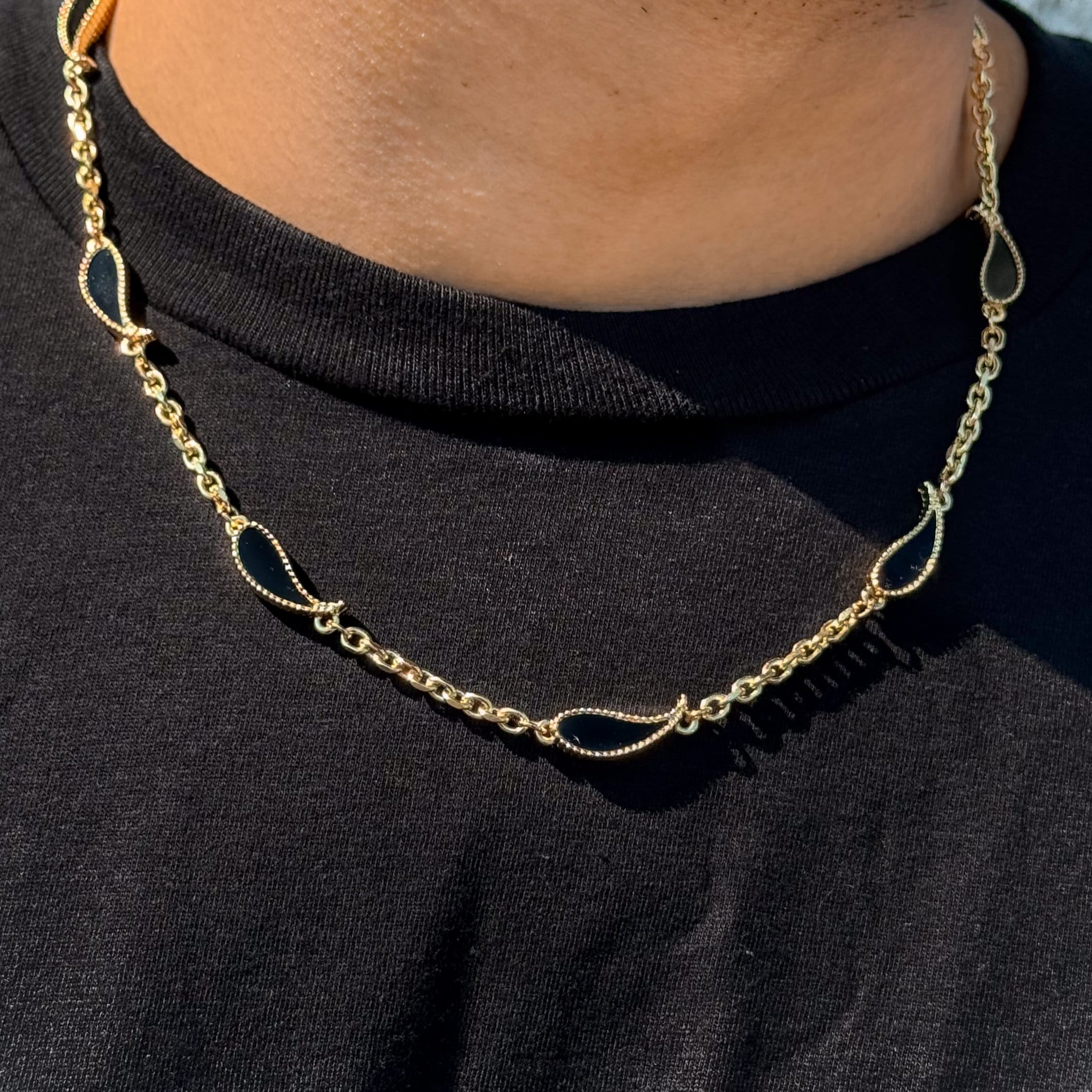 Men's 7mm Black Paisley Multi-Charm Necklace in gold on model, double-sided black teardrop charms.