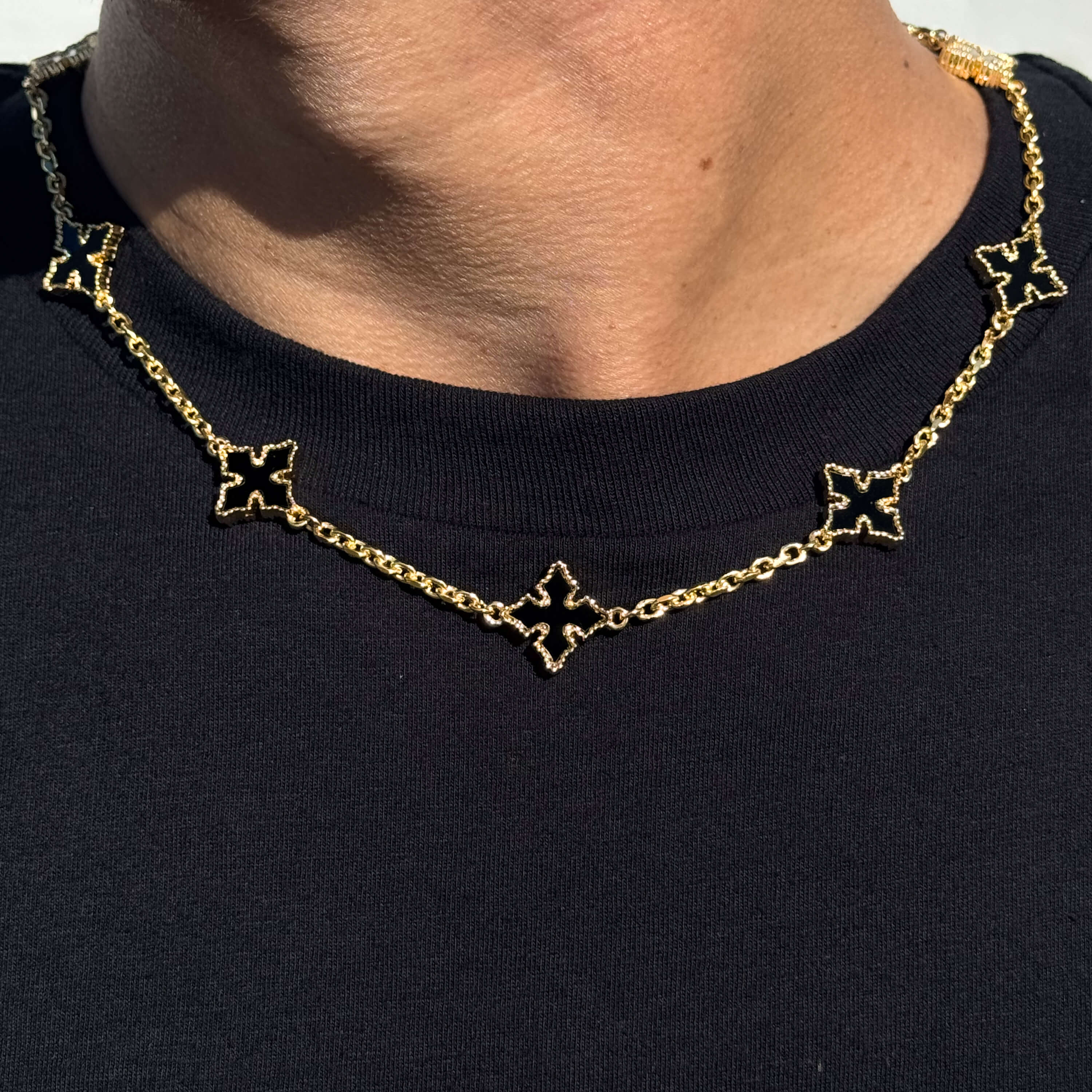 Multi Cross Chrome Inspired Chain - Black in gold with black enamel cross links, close-up worn necklace view.