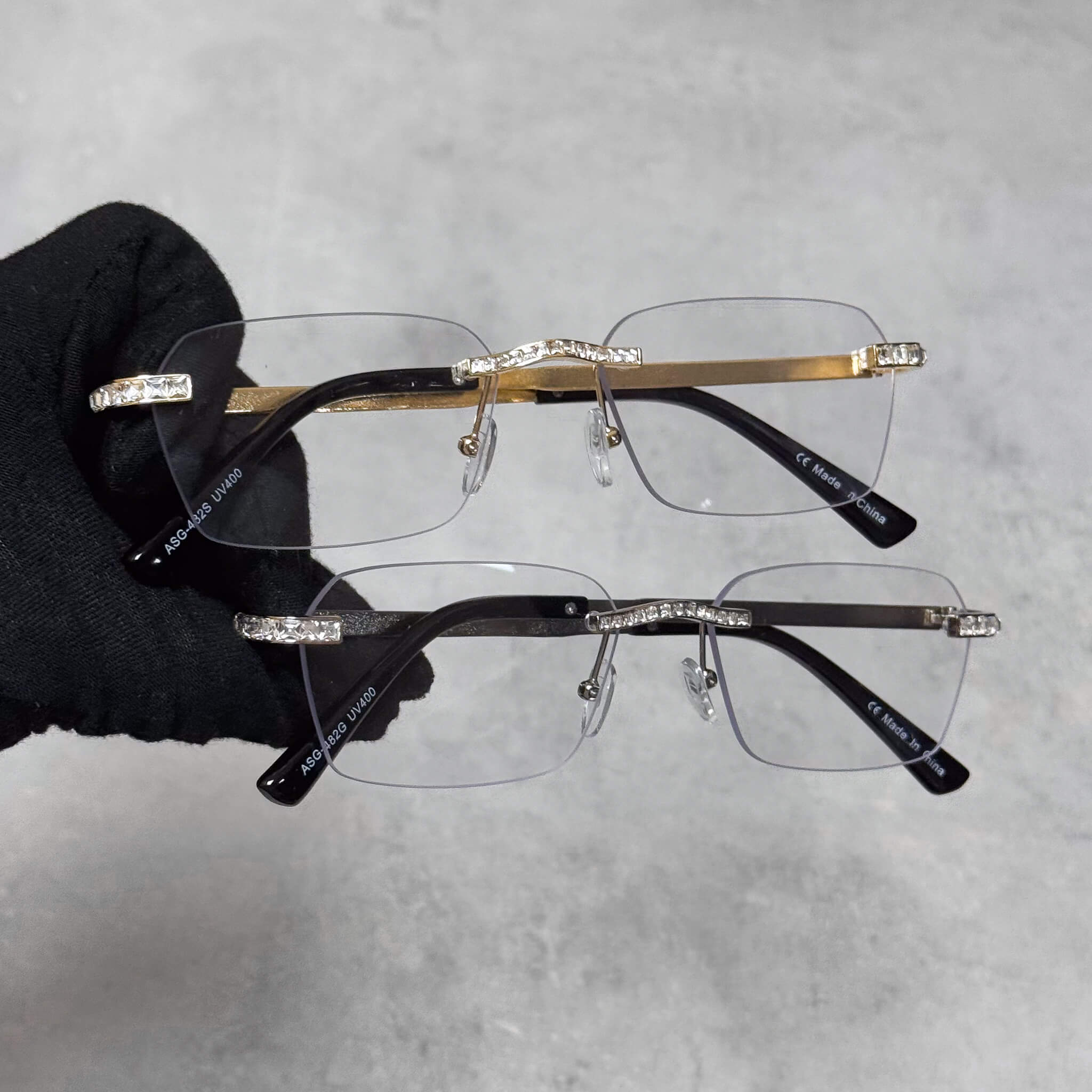 Clear lens Baguette Stone Sunglasses with gold and silver frames and rhinestone detailing.