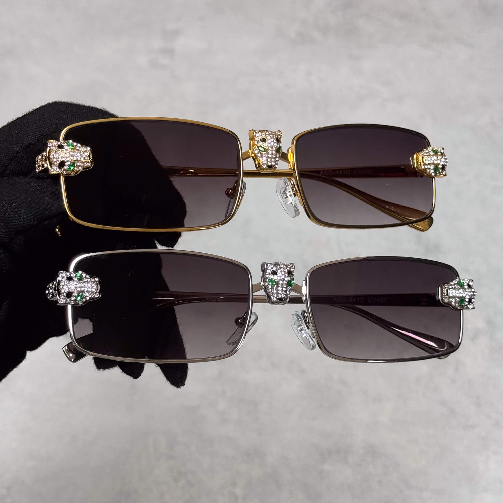 Gold and silver Iced Out Panther Sunglasses with smoke lenses and crystal panther details.