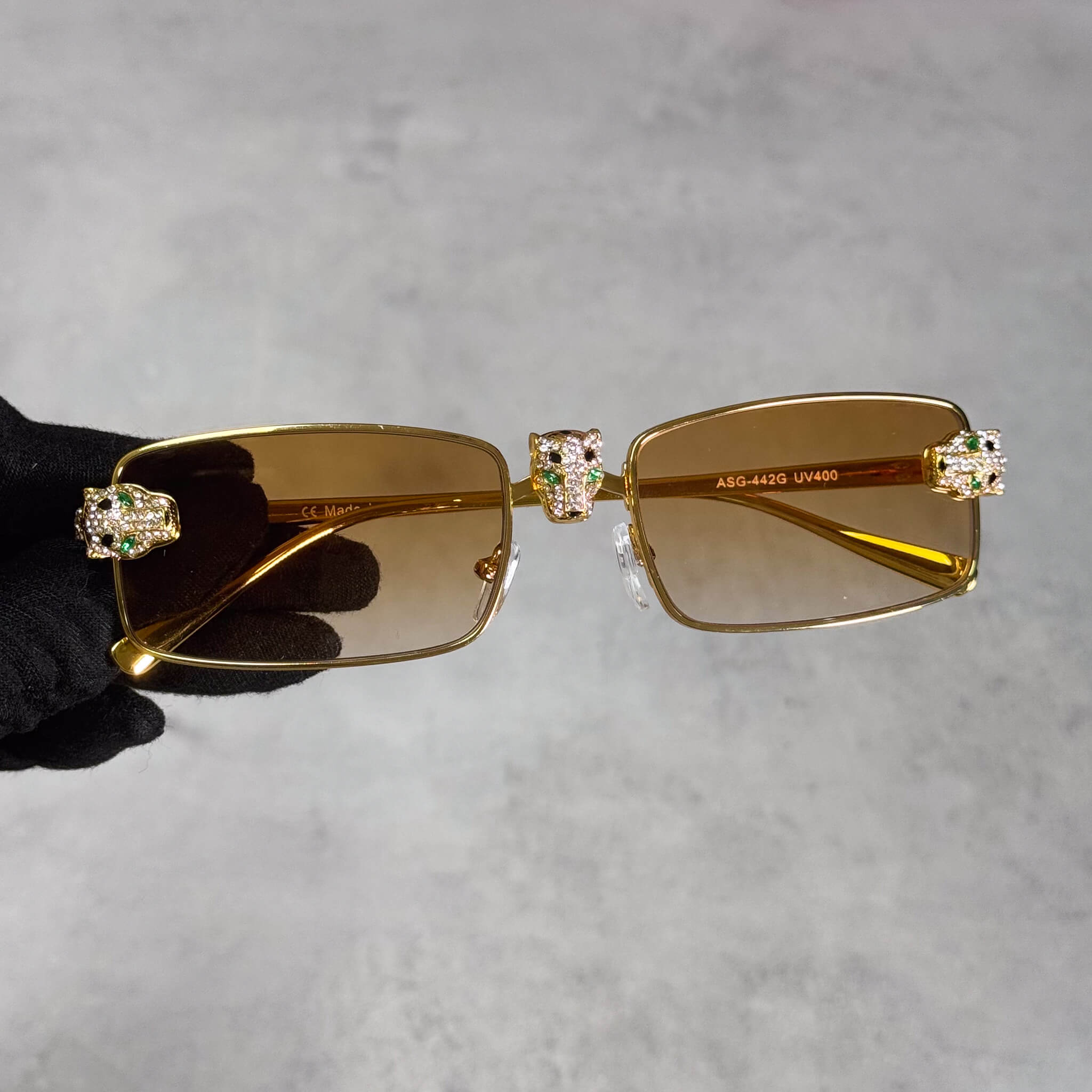 Gold Iced Out Panther Sunglasses with yellow lenses and crystal panther accents on the frame.
