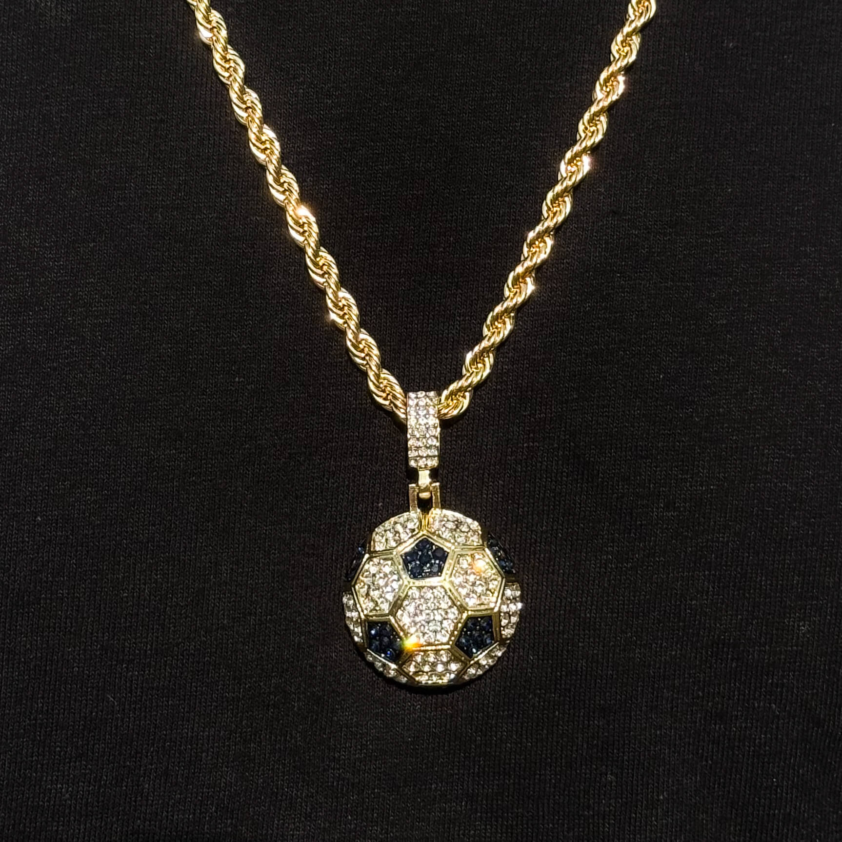 Men's iced out soccer pendant on gold 4mm rope necklace with black and clear stones for athletes.