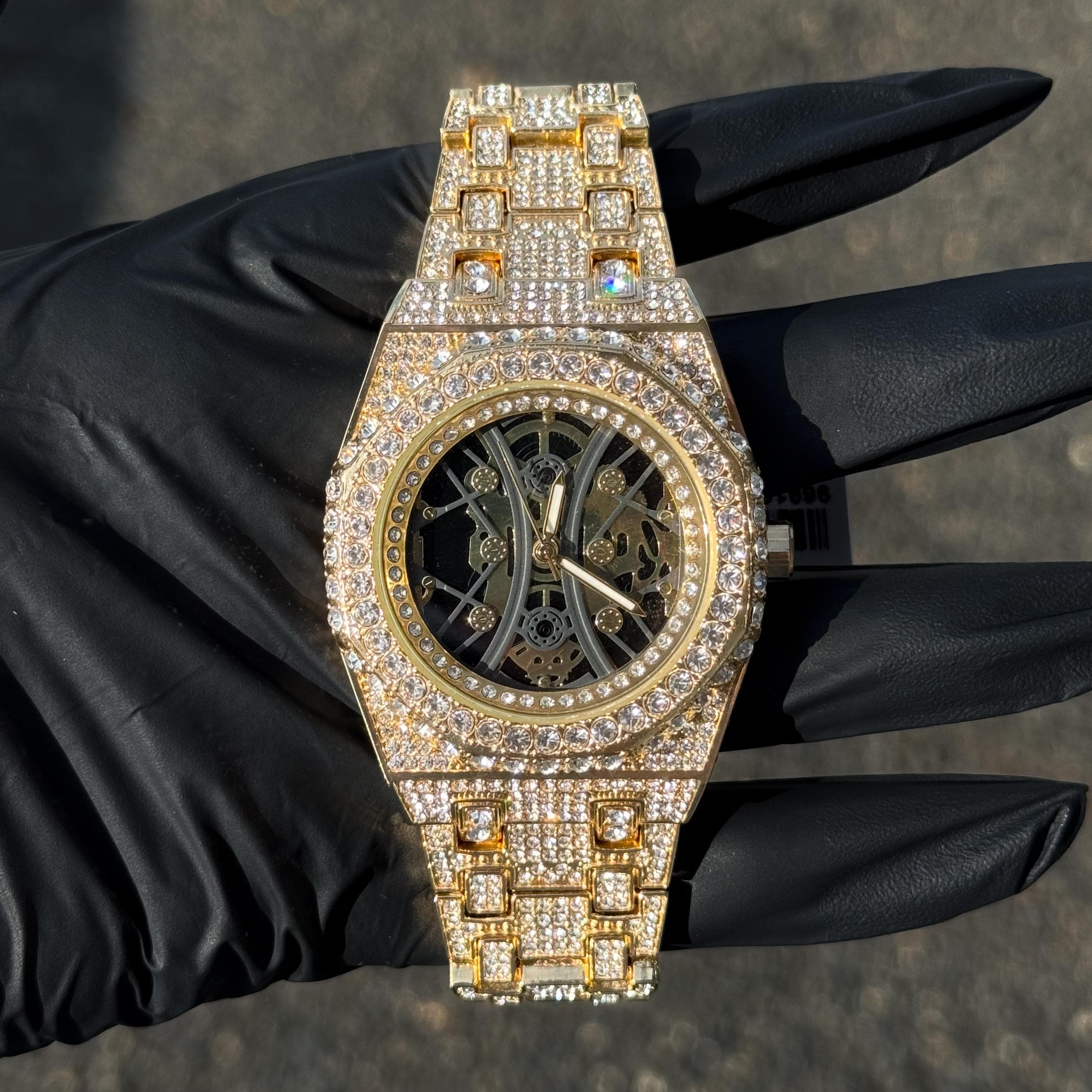 Gold 43mm luxury iced out watch with fully iced band, octagon bezel and skeleton dial for men.