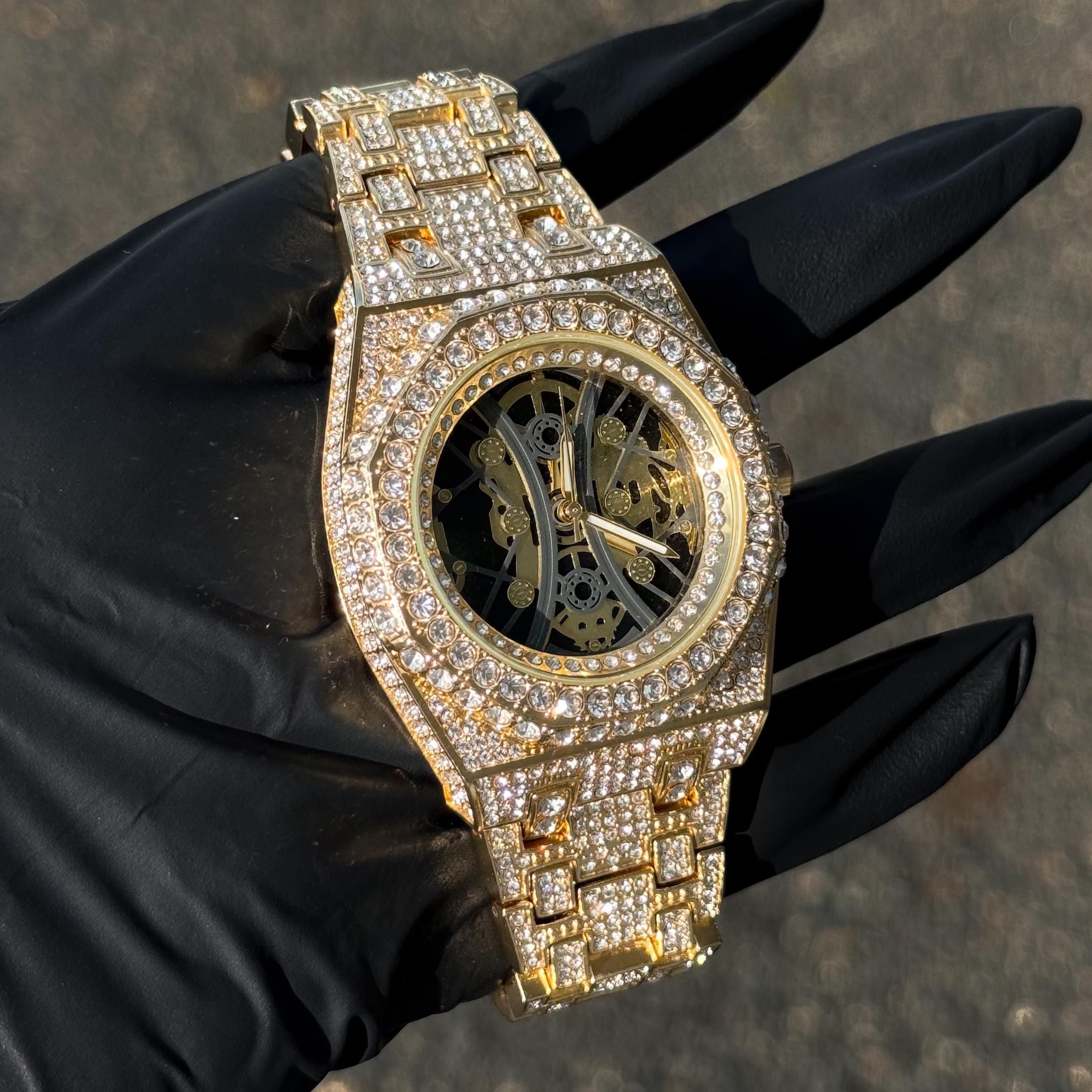 Men's gold luxury iced out watch featuring full diamond band, octagon bezel and skeleton dial.