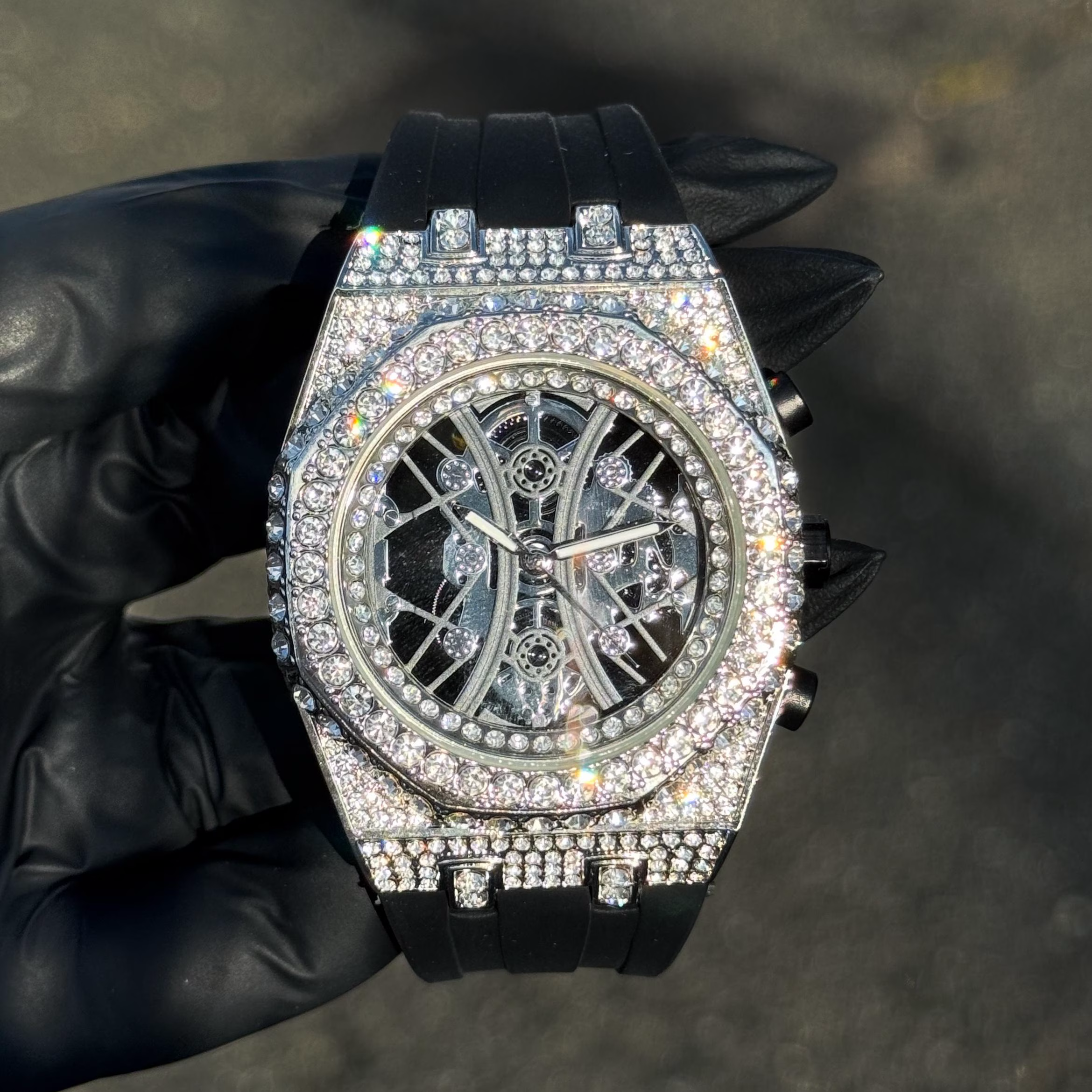 Silver Men’s 43mm iced out octagon bezel watch with skeleton dial and silicone band.