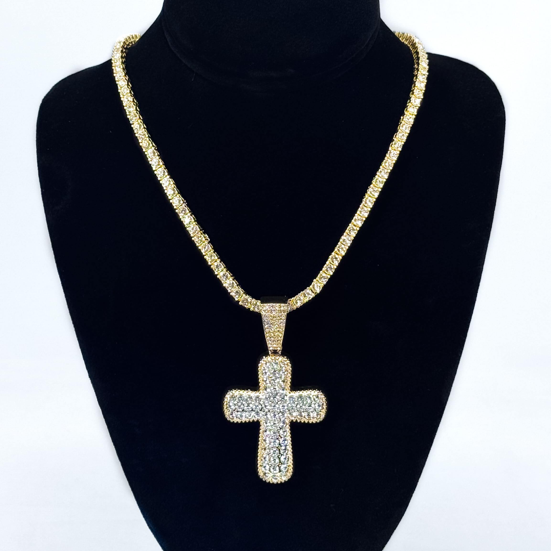 Ladies 40mm iced-out gold cross pendant necklace with 4mm tennis chain displayed on jewelry bust.