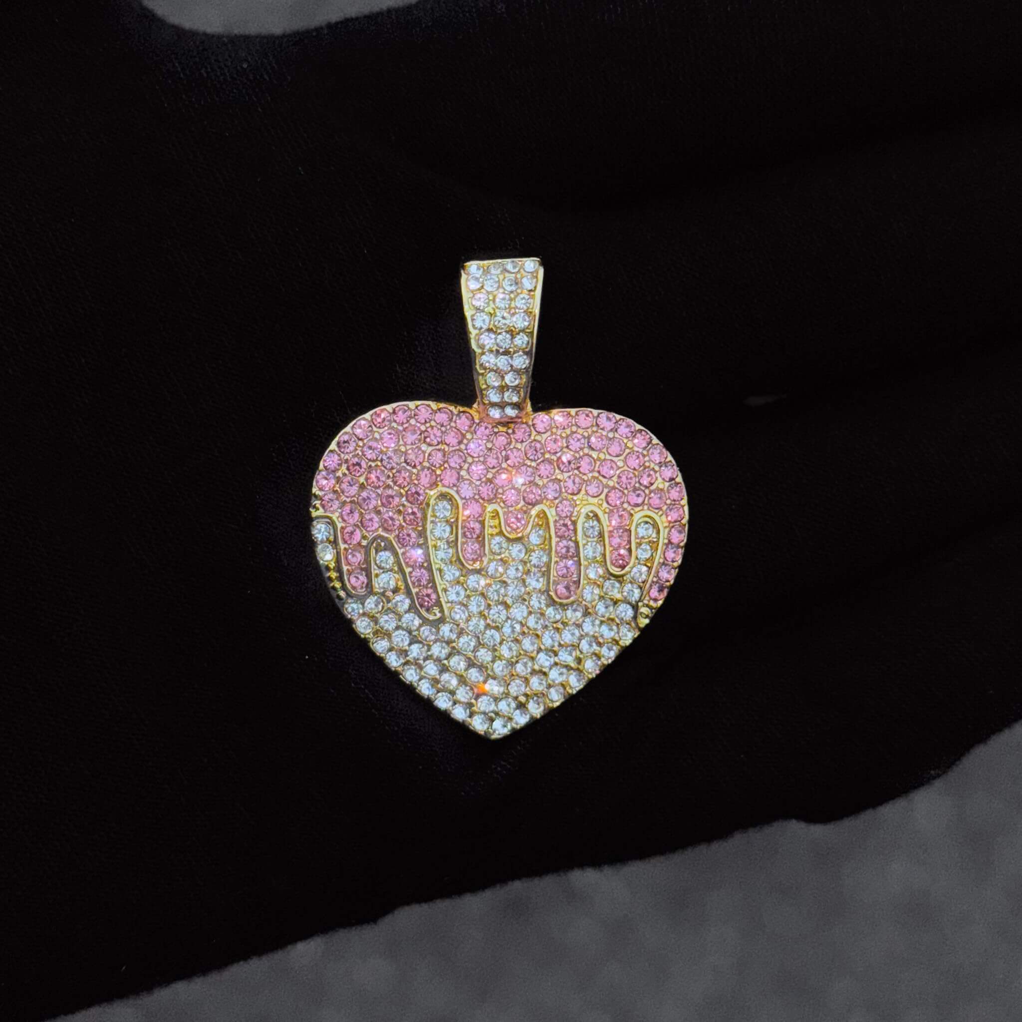Ladies 32mm iced-out gold Heart pendant necklace with 4mm rope chain displayed on jewelry stand.