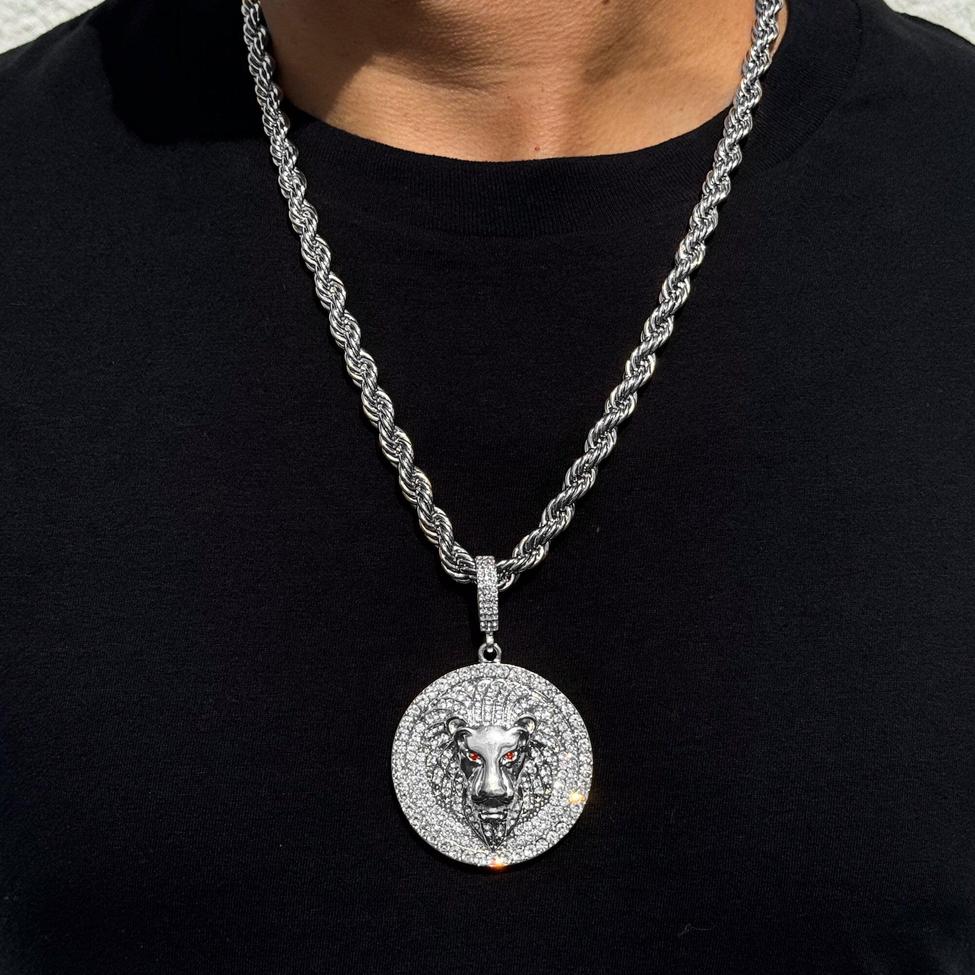 Men’s large iced-out lion medallion pendant in silver with 8mm rope chain and red gem eyes.