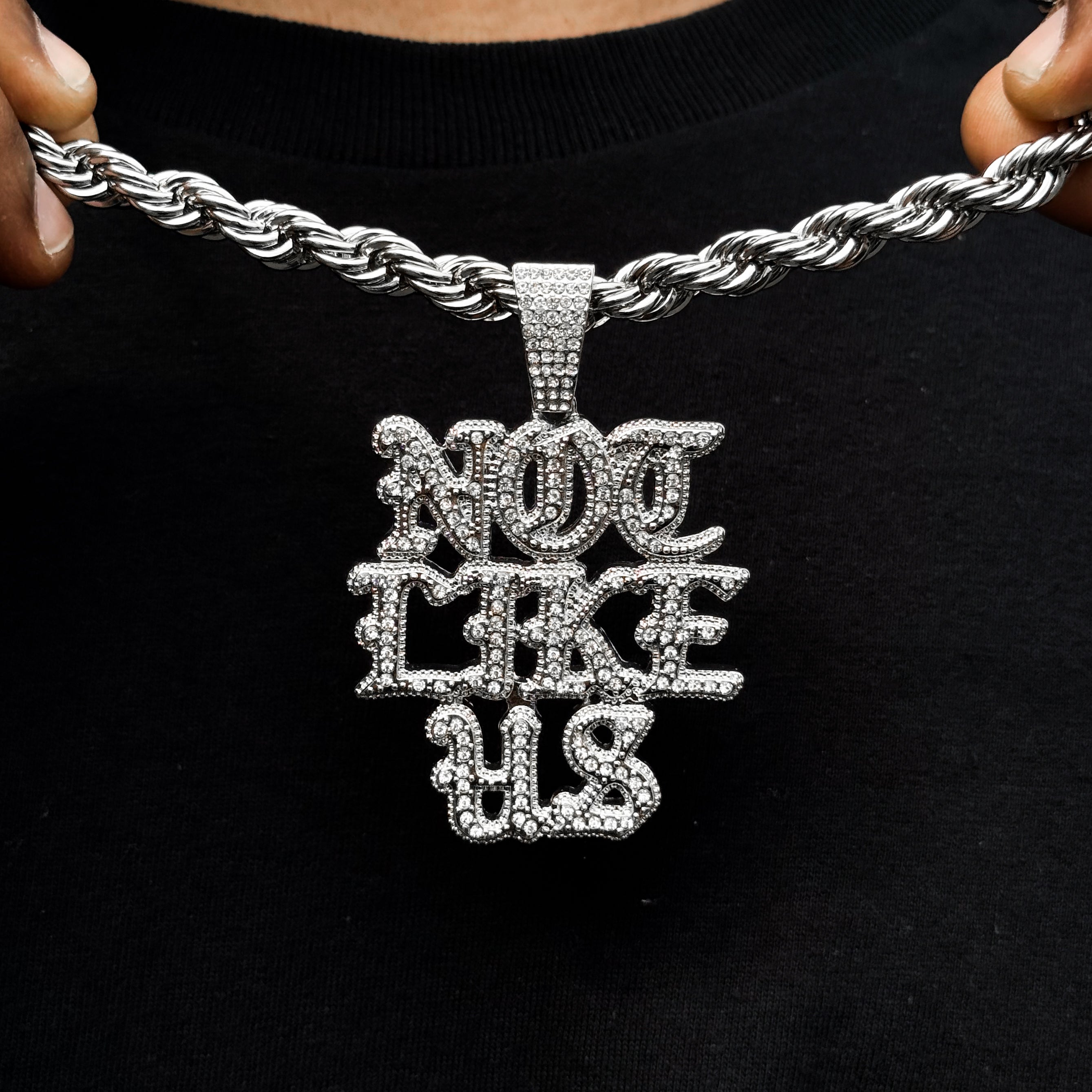Silver iced out Not Like US pendant on thick 8mm rope chain shown worn for detailed view.
