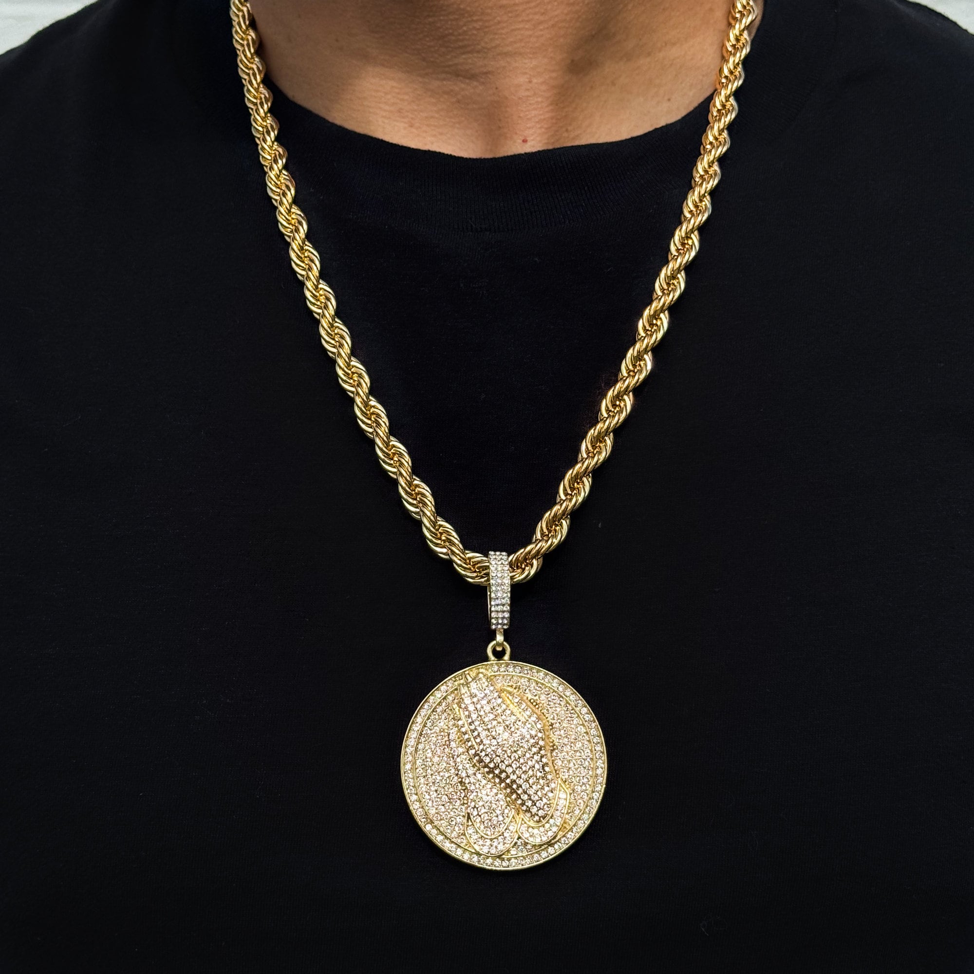 Men’s large gold iced-out praying hand medallion pendant on an 8mm rope chain with detailed stones.