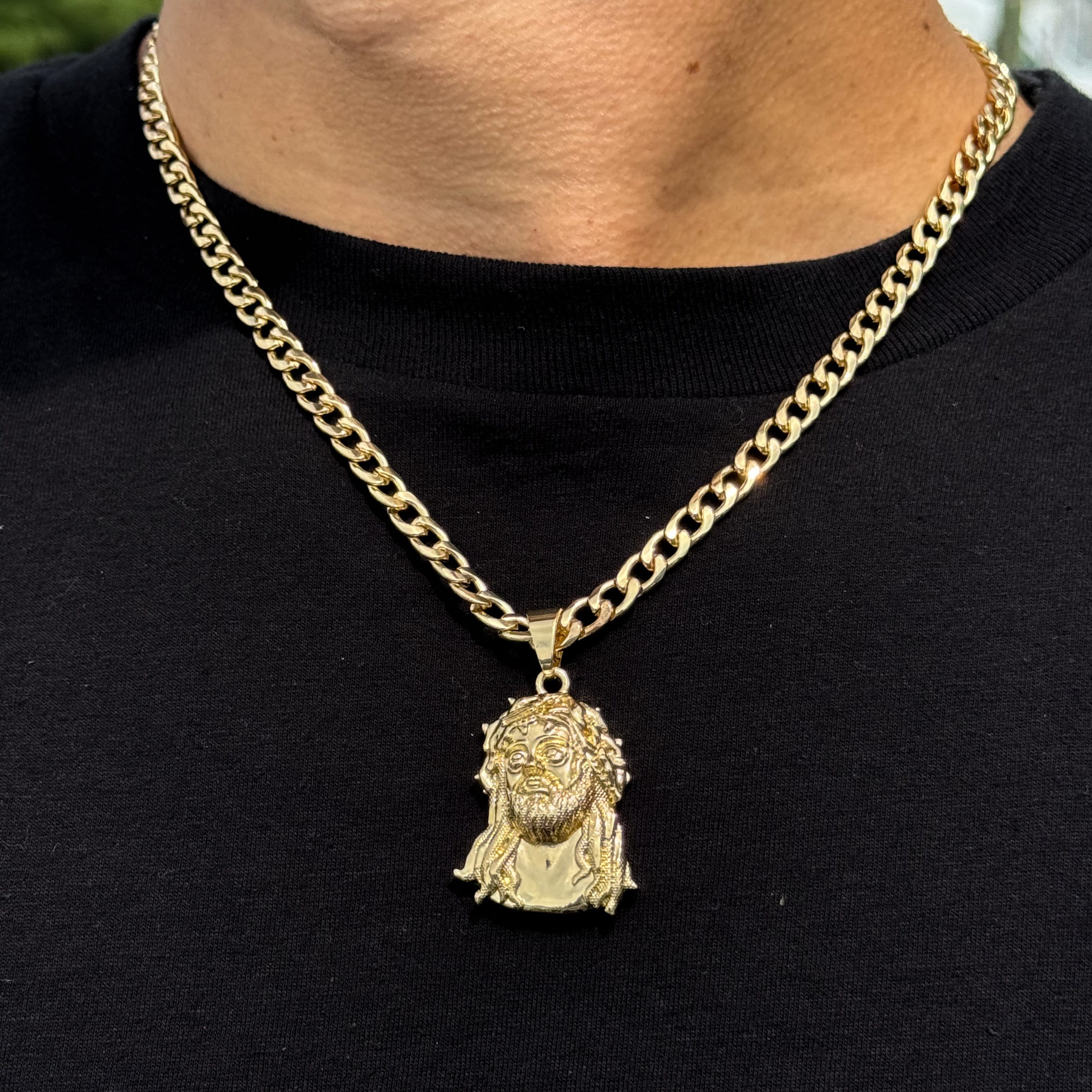 Men’s medium gold Jesus pendant on a 5mm Cuban chain, detailed face and crown design.