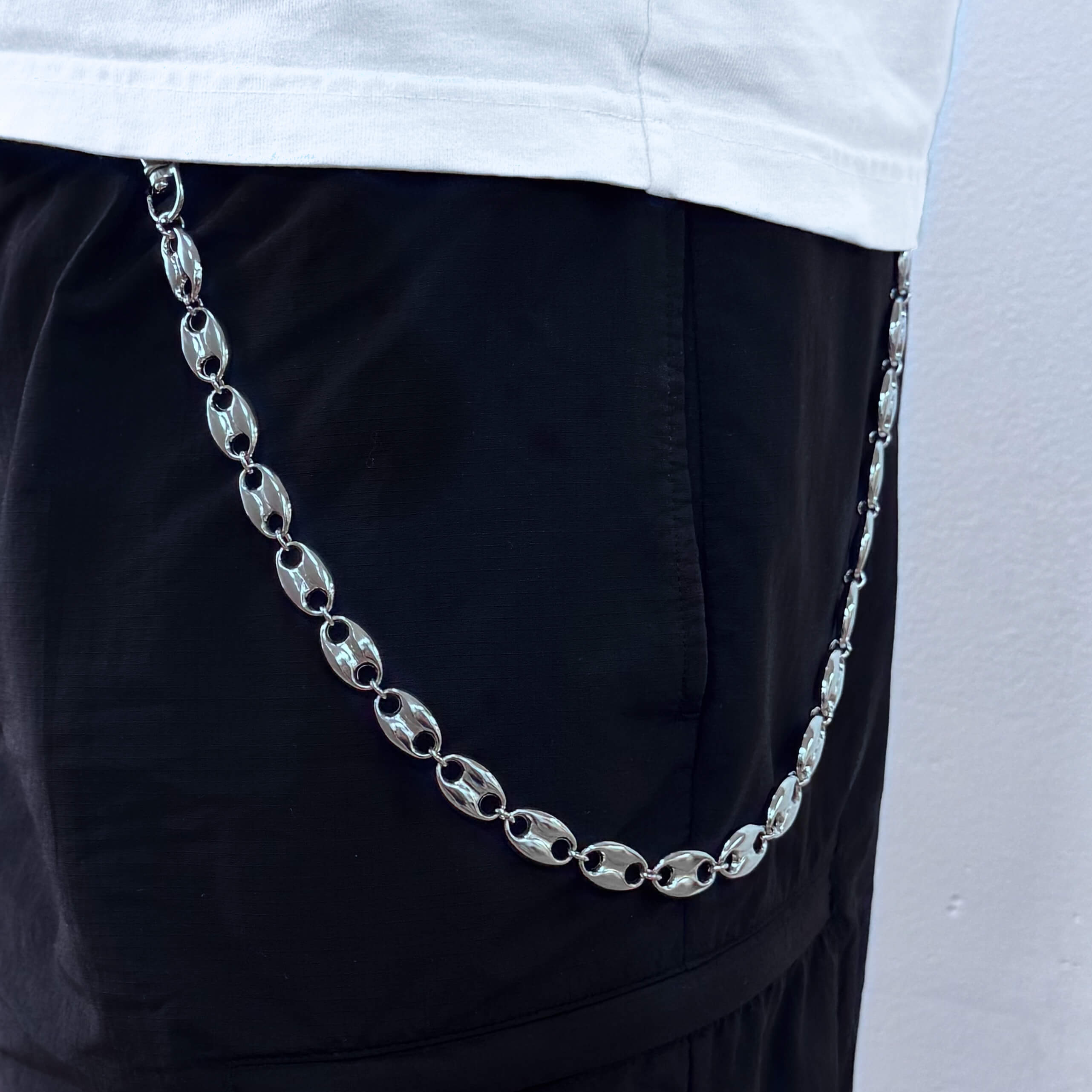 Silver mariner link pant chain worn with black pants, a bold accessory for streetwear.