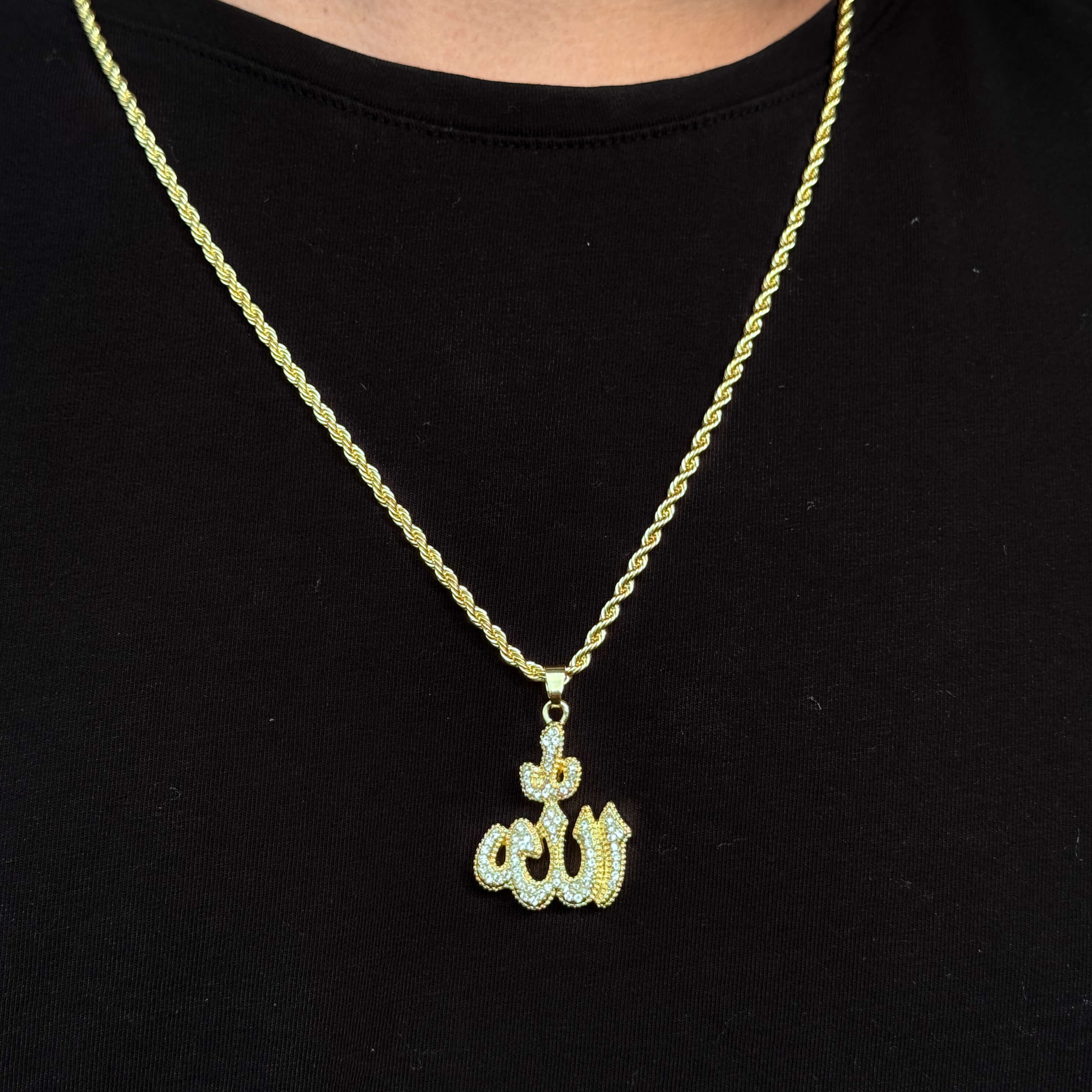 Gold Men's 26mm Iced-Out Allah Pendant Necklace with 5mm rope chain on black shirt.