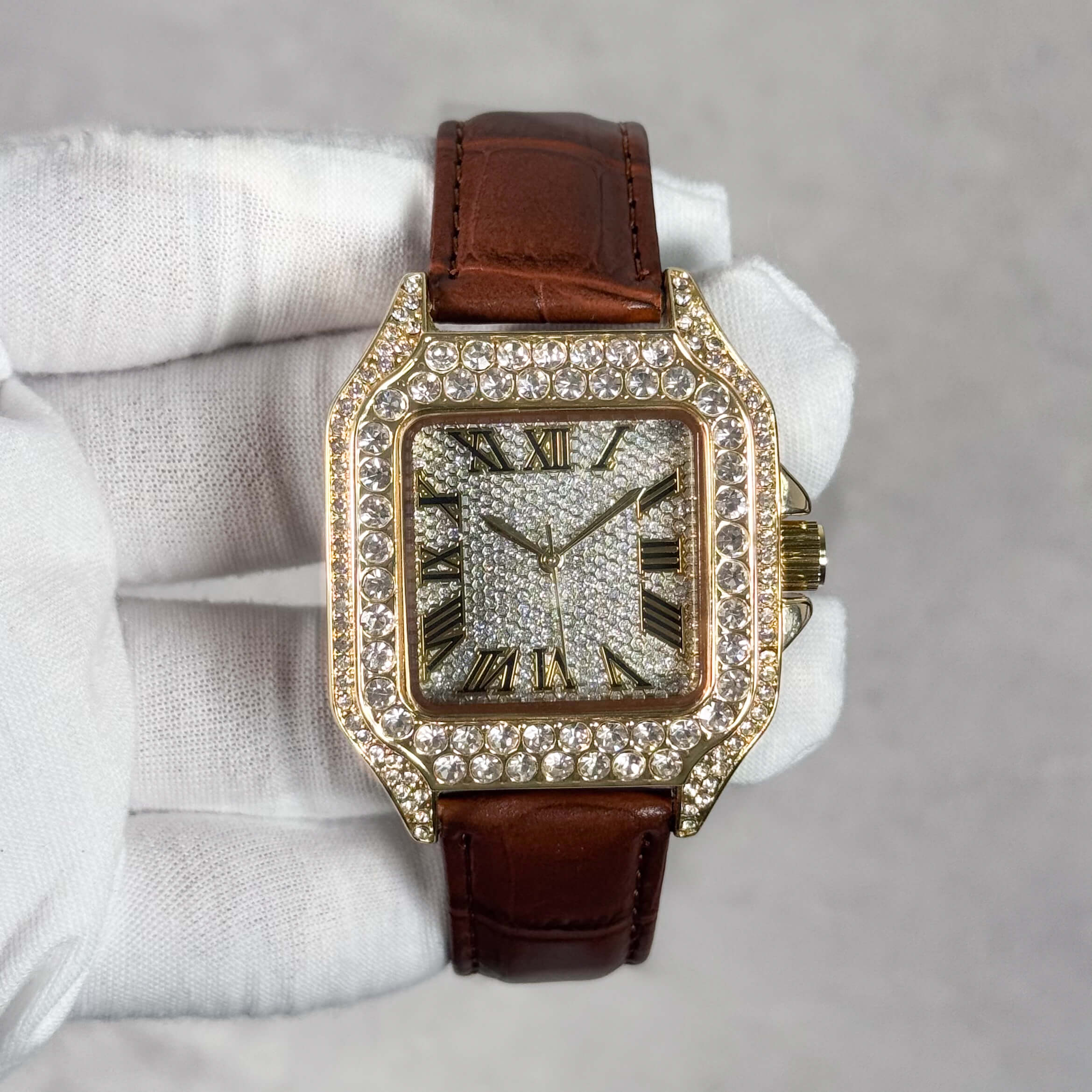 Men's 32mm fully iced out square dial watch with gold case and brown leather band.
