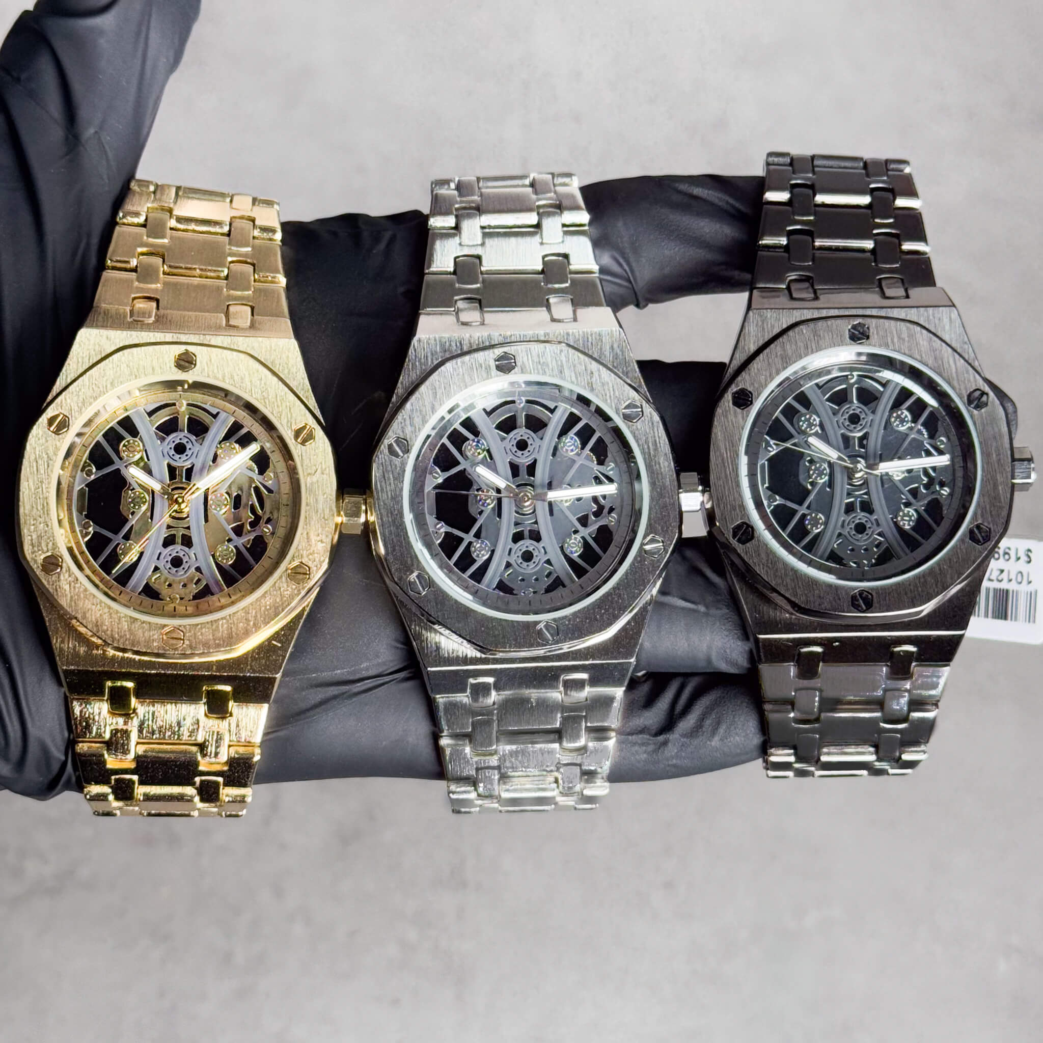 Men's 40mm octagon bezel skeleton watches in gold, silver, and black with metal link bands.