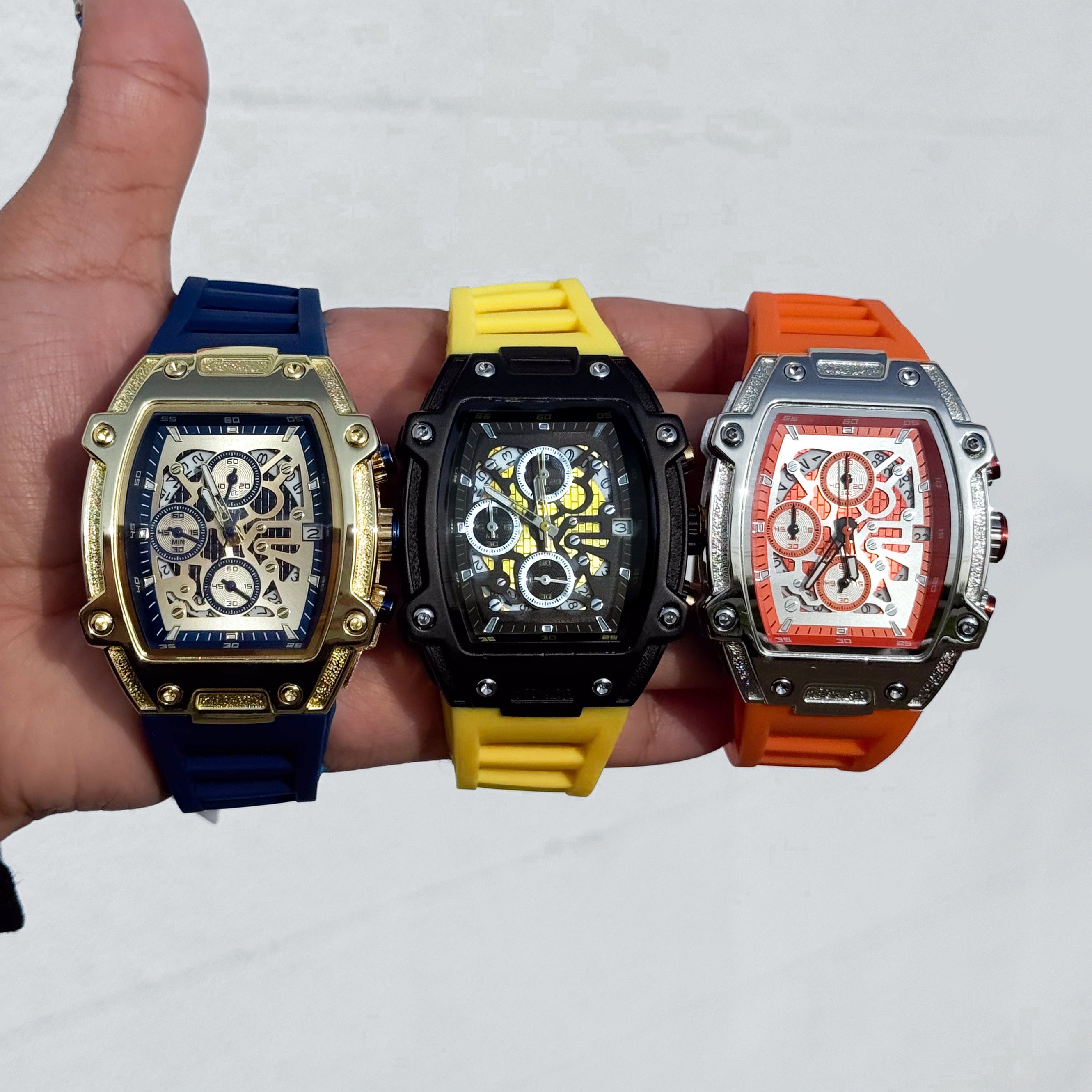 Blue, yellow, and orange Men's 41mm silicone band tonneau watches with skeleton-style quartz dials.