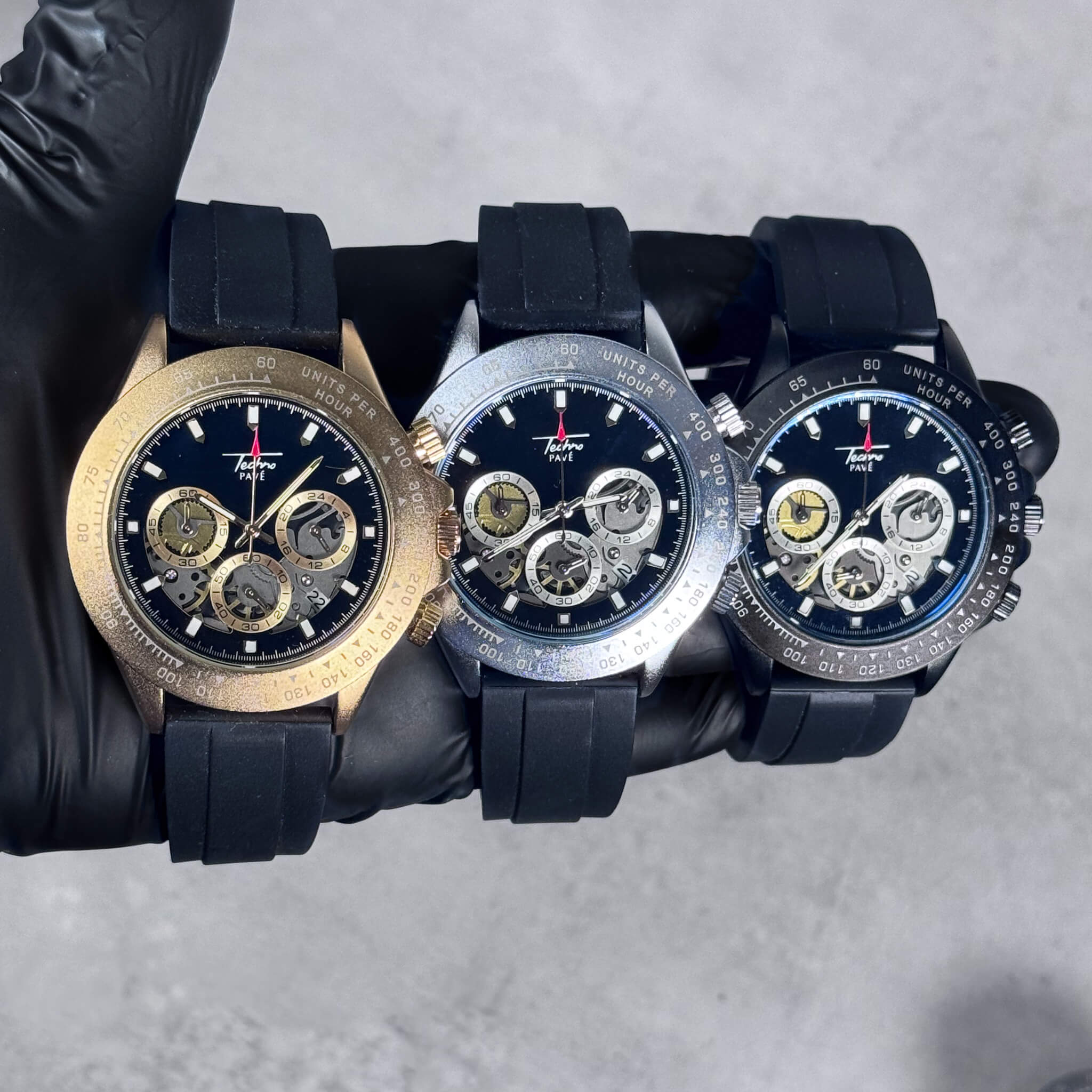Gold, silver, and black Men’s 42mm silicone chronograph watches with multi-dial quartz faces.