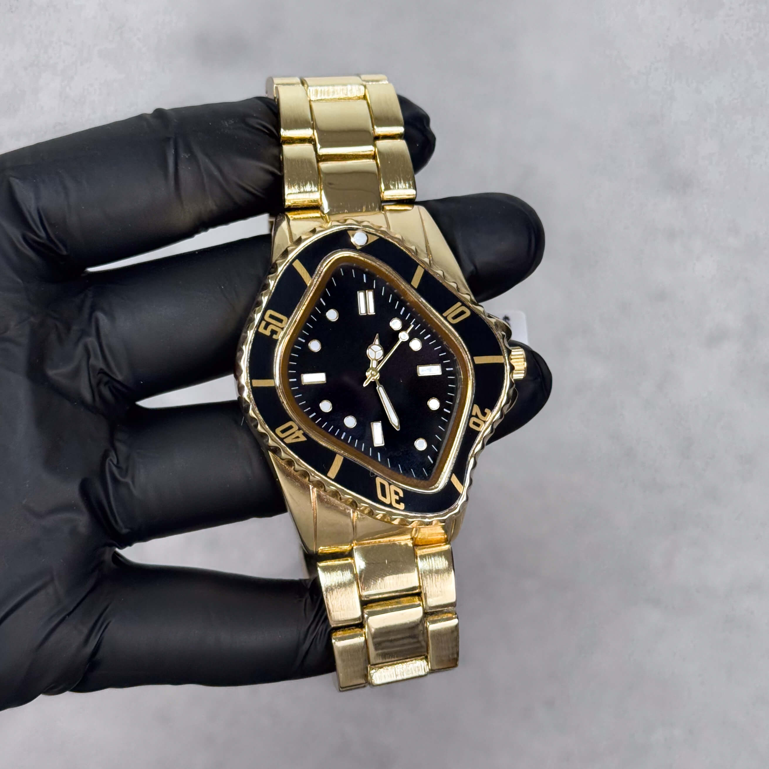 Gold Men’s 42mm warped case watch with black dial, metal band, and unique quartz design.