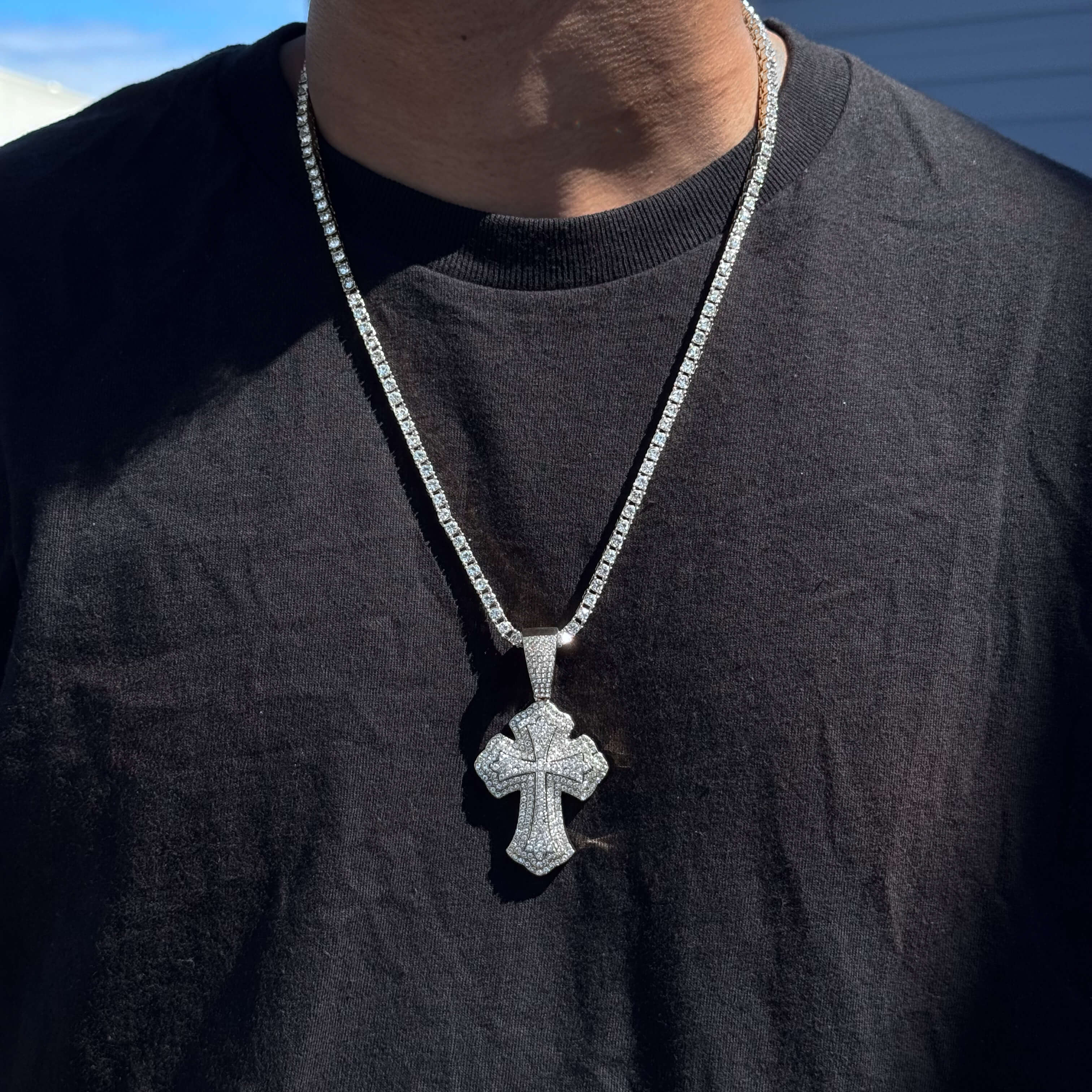 Silver men’s 42mm iced-out cross pendant on 5mm tennis chain with pavé clear stones.