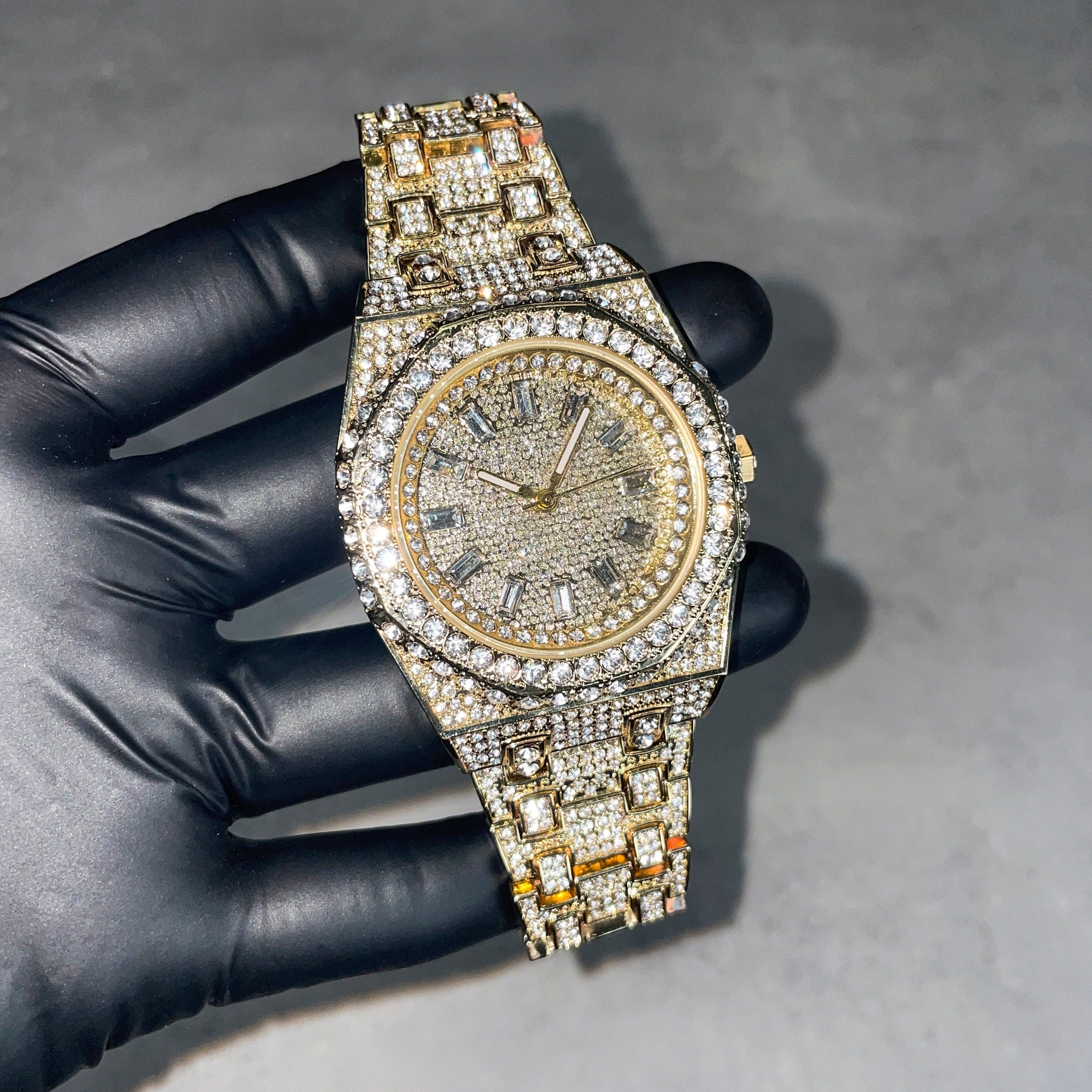 Gold men’s 43mm iced out diamond watch with octagon bezel, baguette markers, and fully iced band.