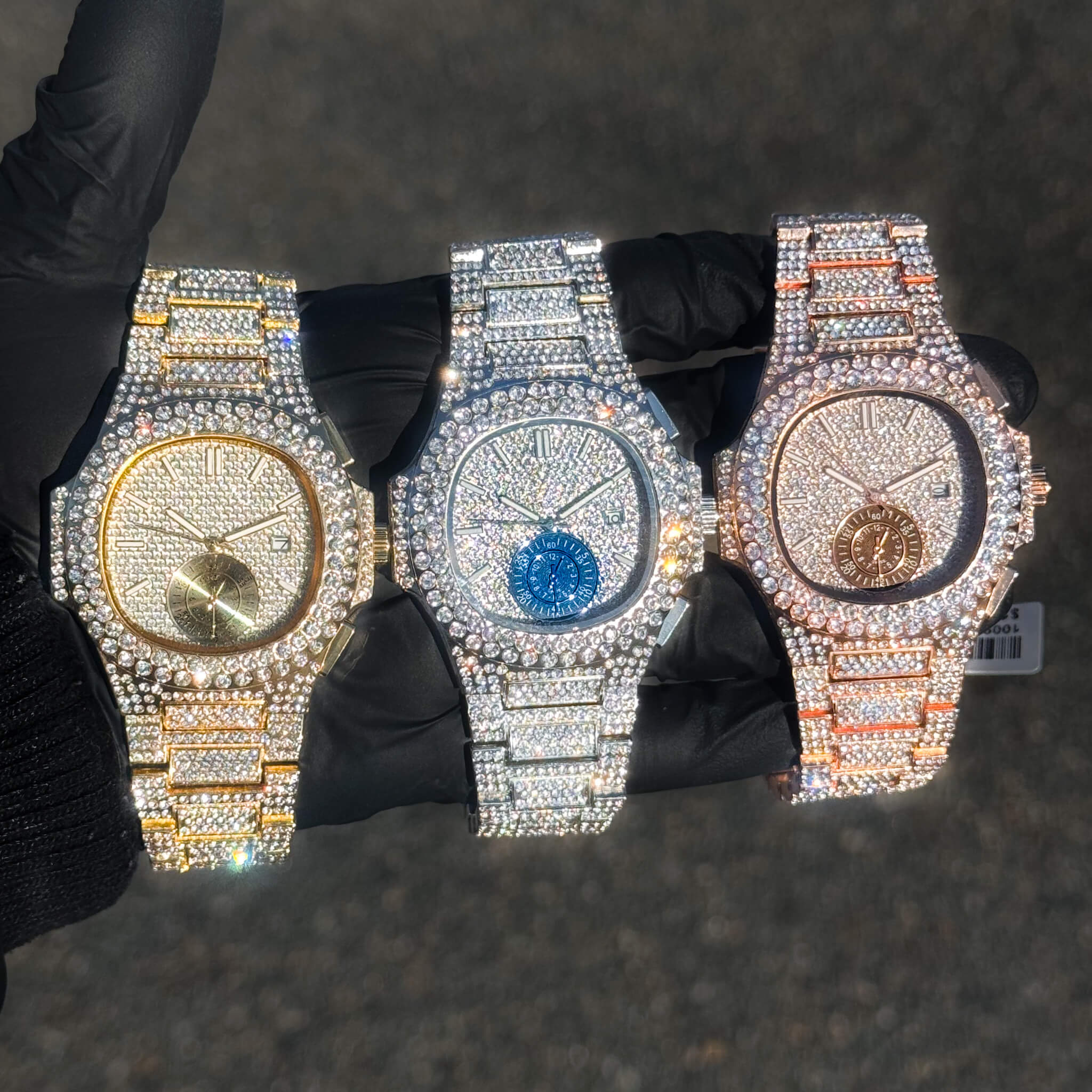 Men's 43mm iced-out diamond watches in gold, silver, and rose gold with full crystal settings.
