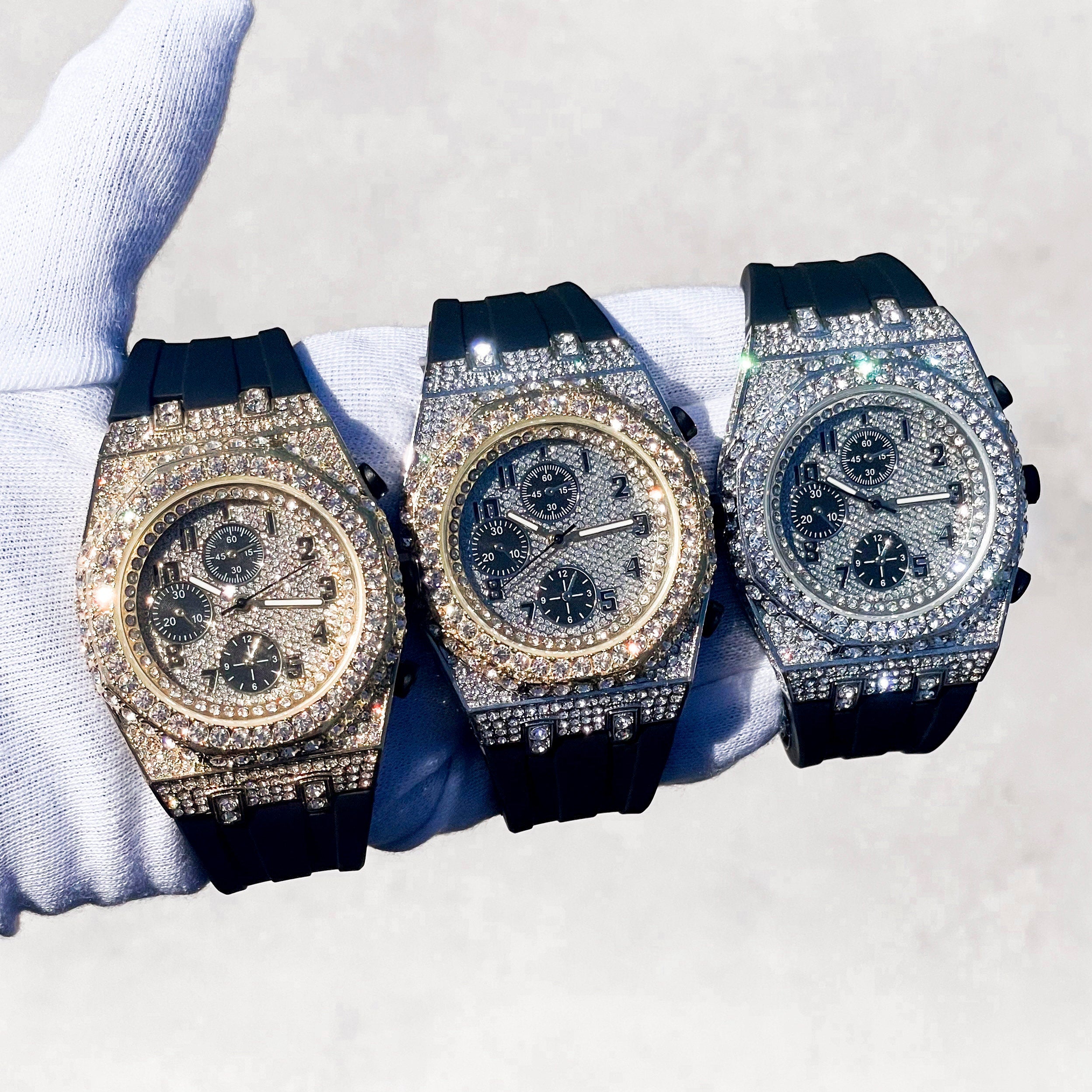 Men's 43mm iced out octagon bezel diamond watches in gold, silver and rose tones with black silicone bands.