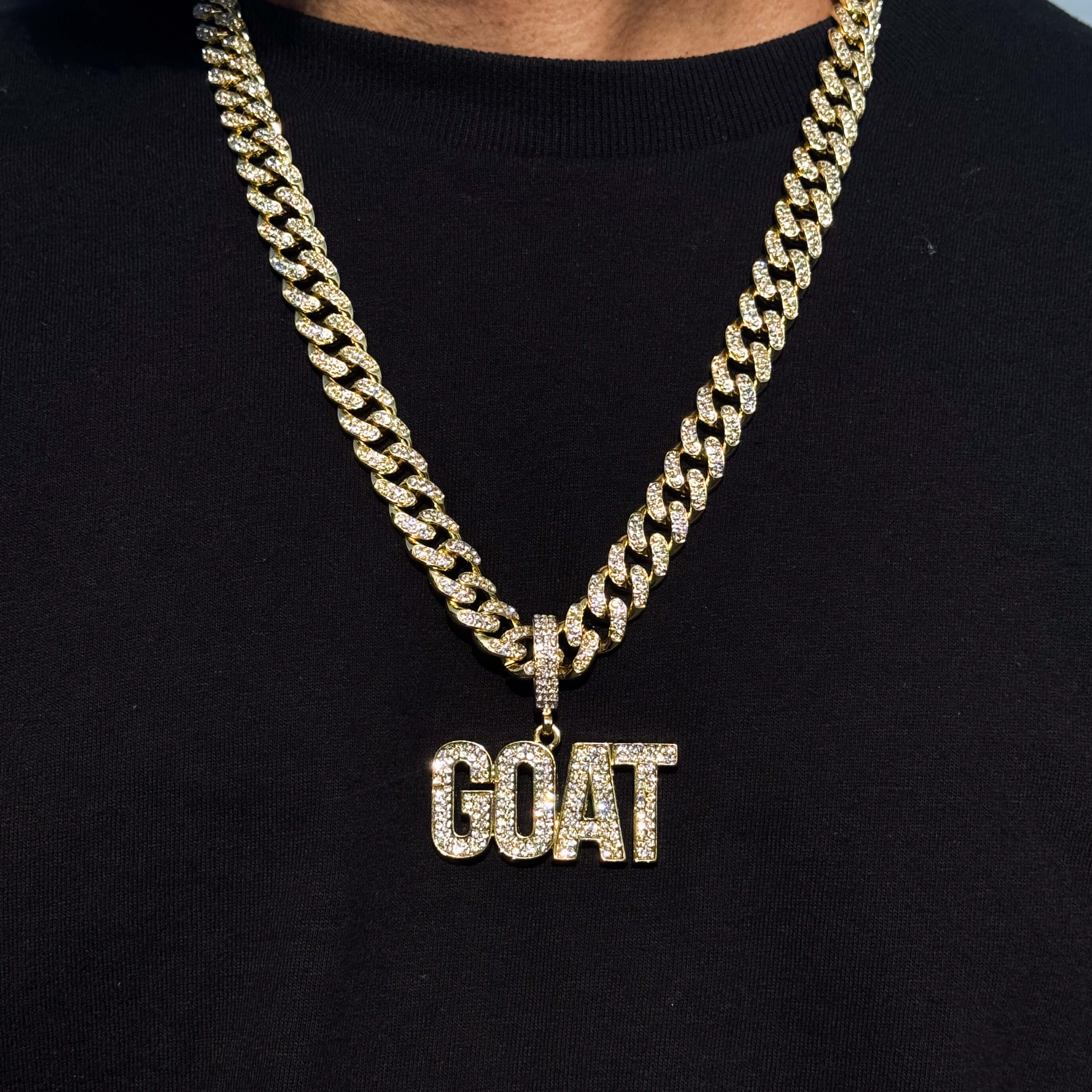 Gold iced-out GOAT pendant with large 12mm Cuban chain, bold letters and clear stones
