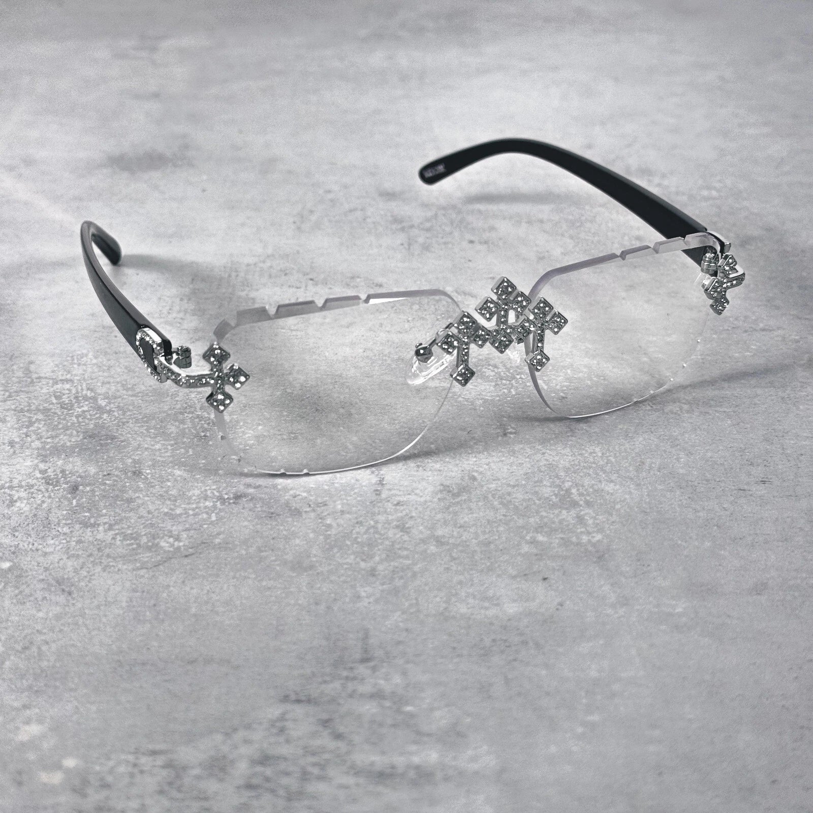Iced Triple Cross Sunglasses in clear lens with black temples and crystal cross detailing.