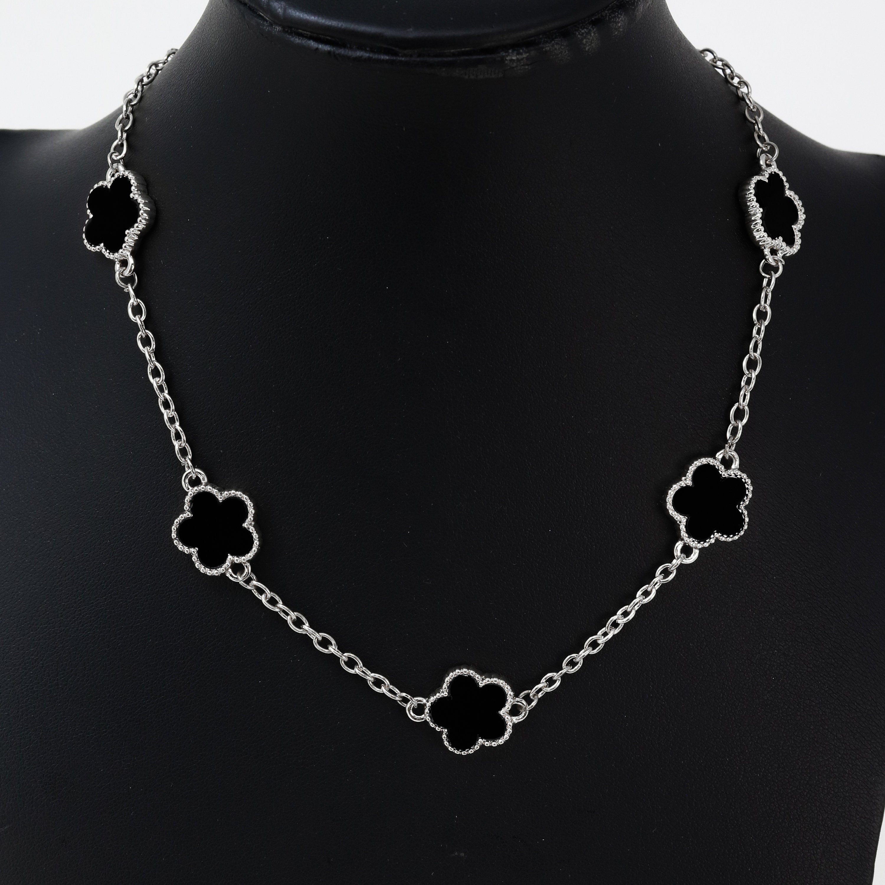 Men's 15mm 5-Leaf Clover Link Chain Necklace in silver finish with glossy black clover charms on display bust.