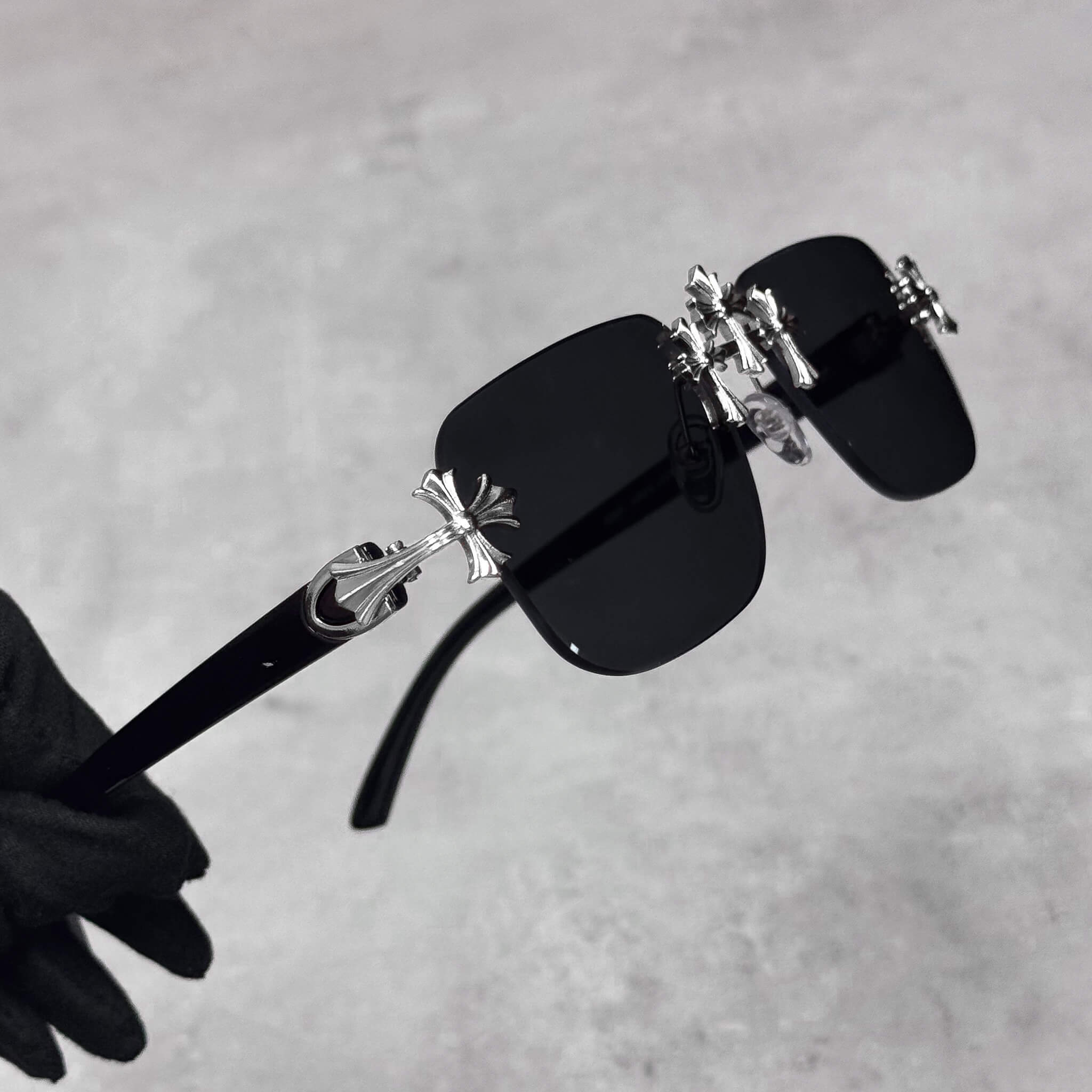 Black Triple Cross Sunglasses with silver cross side hardware and square rimless lenses.