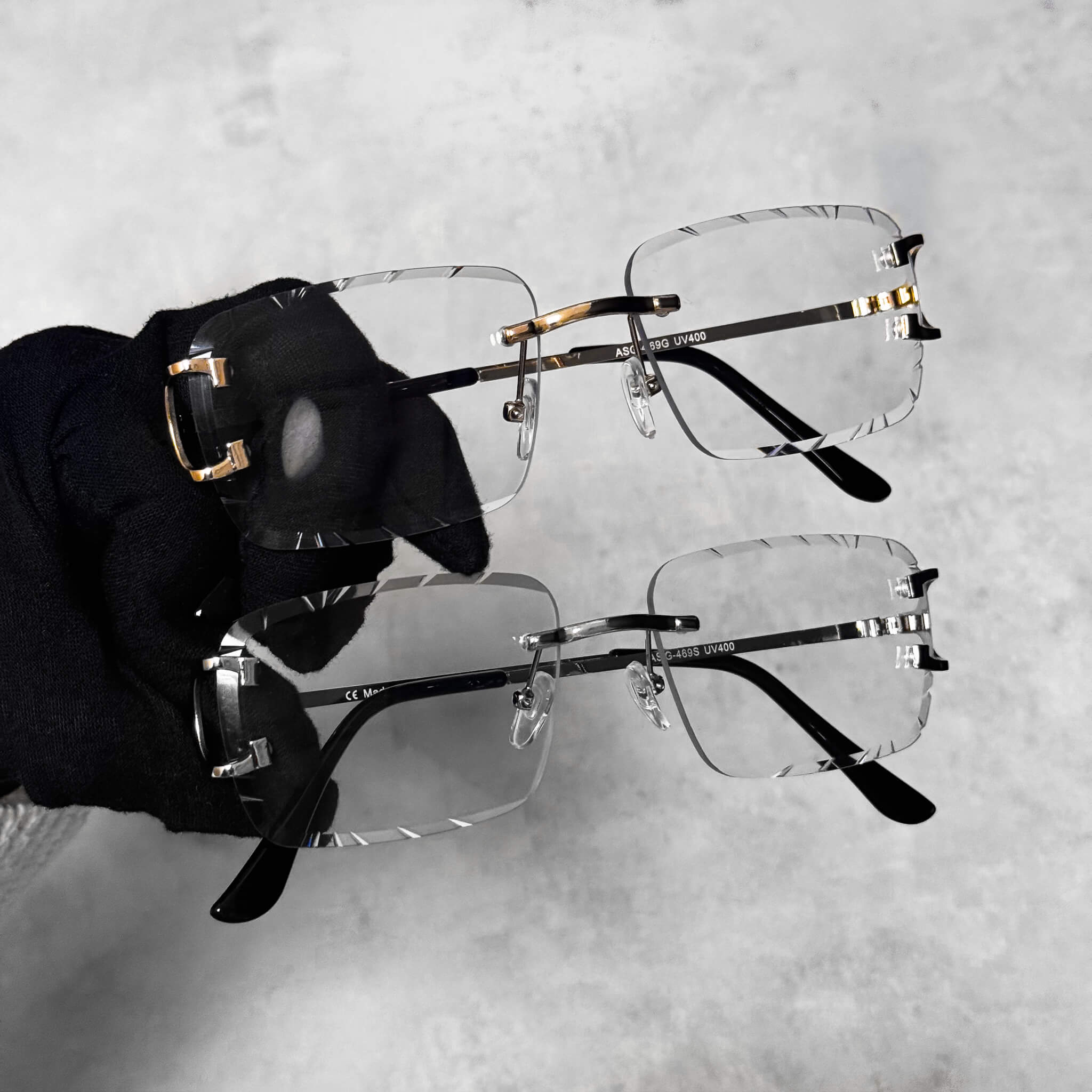 Solid Cut-Edge Sunglasses with clear square lenses and gold and silver metal frame detail.