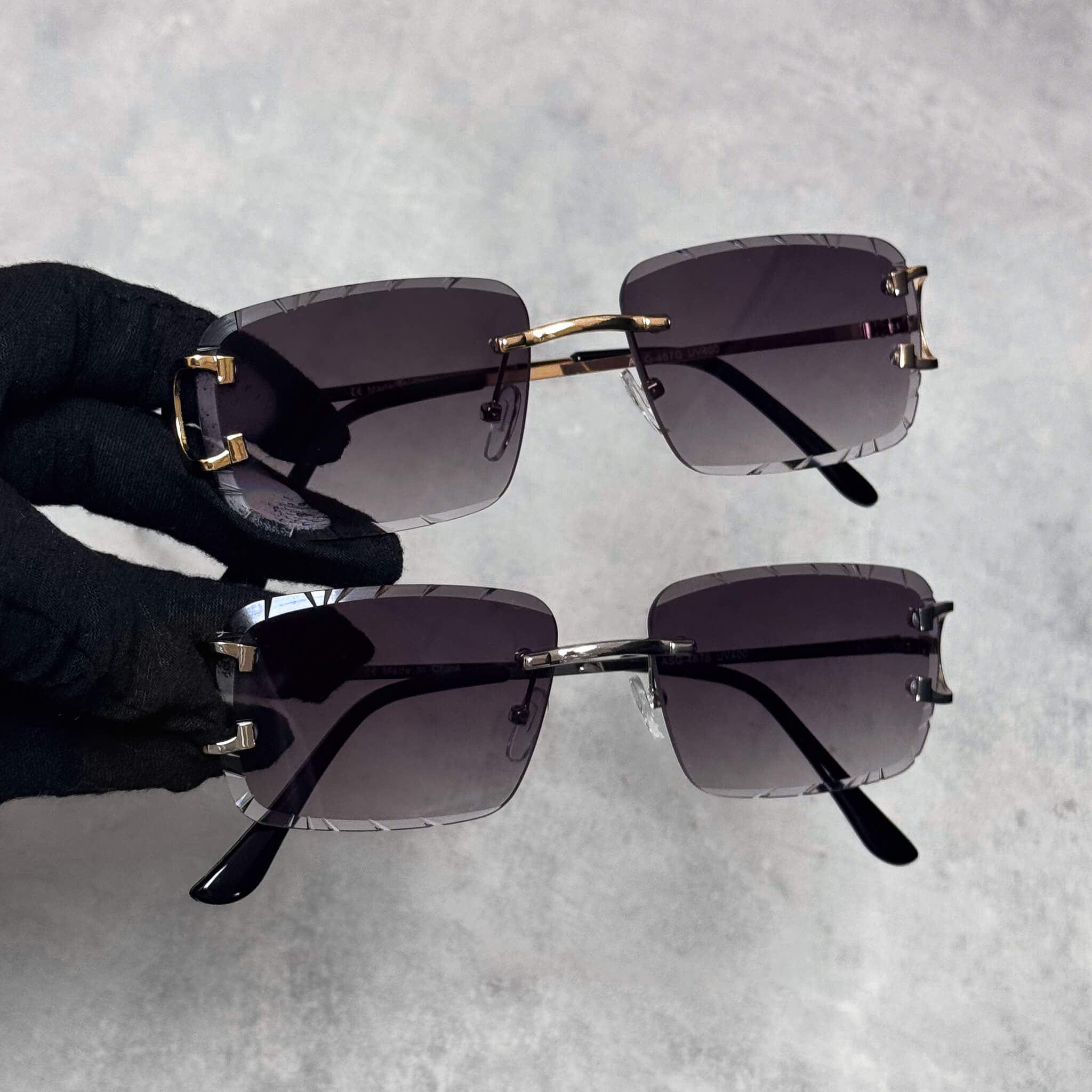 Black smoke cut-edge sunglasses with silver and gold bridge and square lenses, Solid Cut-Edge design.