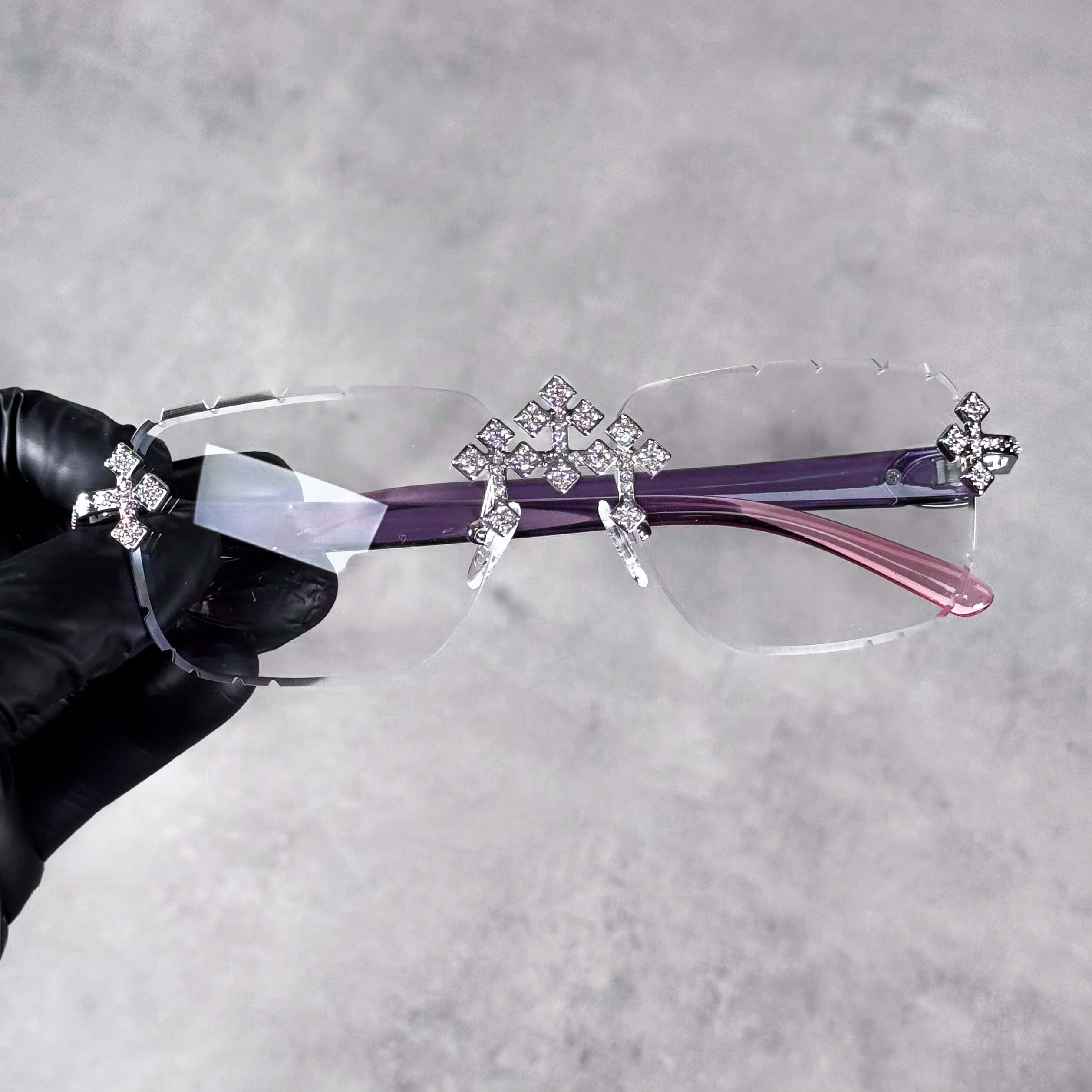 Iced Triple Cross Sunglasses with clear rimless lenses and purple-pink gradient arms.