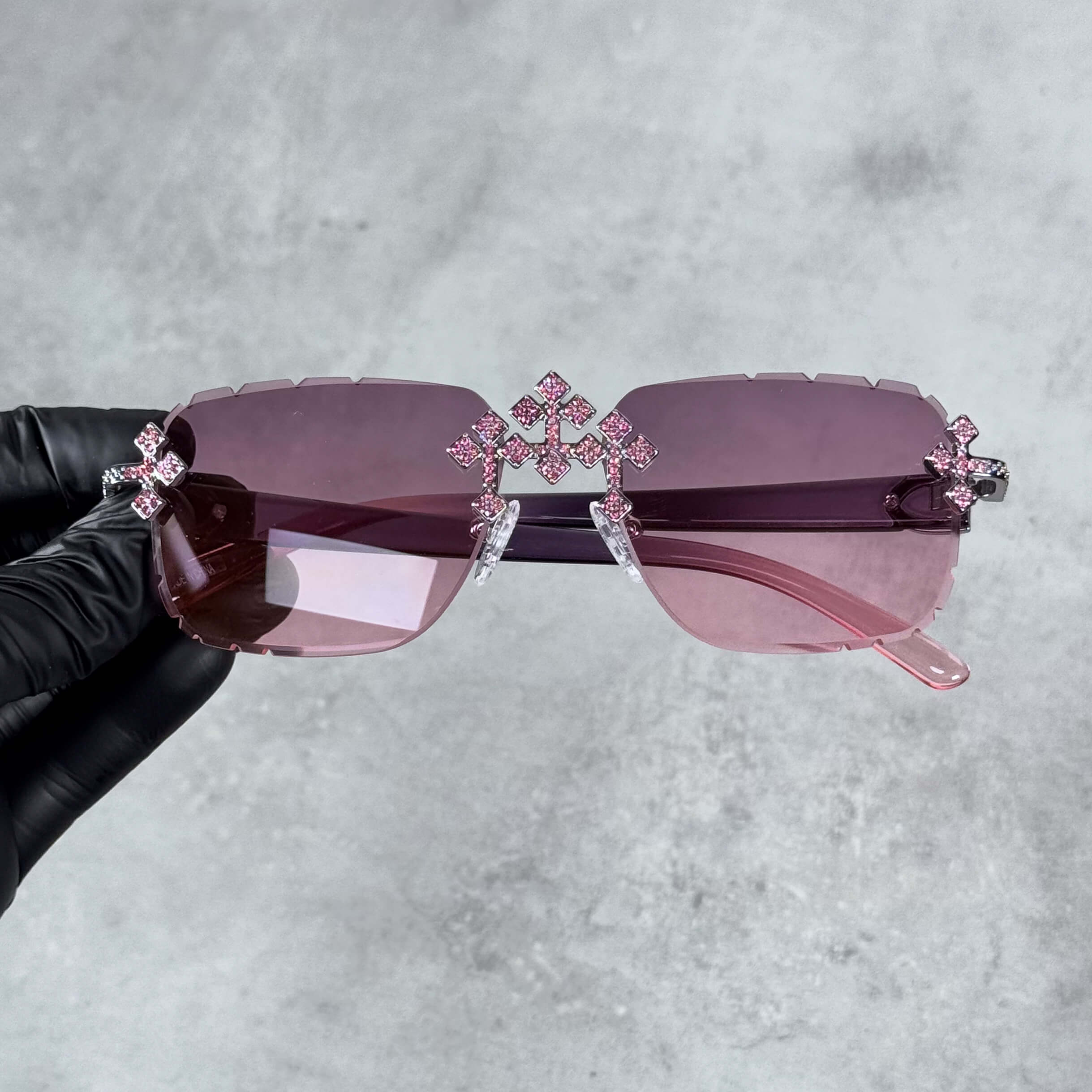 Iced Triple Cross Sunglasses with pink gradient lenses and crystal cross accents on rimless frame.