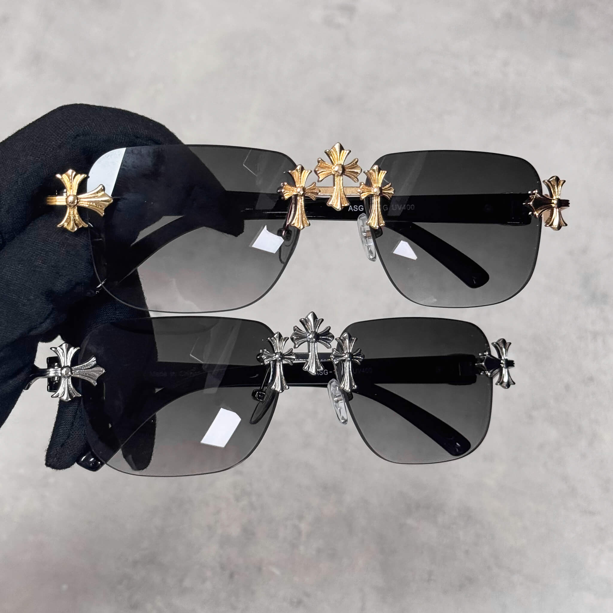 Solid Triple Cross Sunglasses with smoke lens and gold or silver cross accents on black frame.