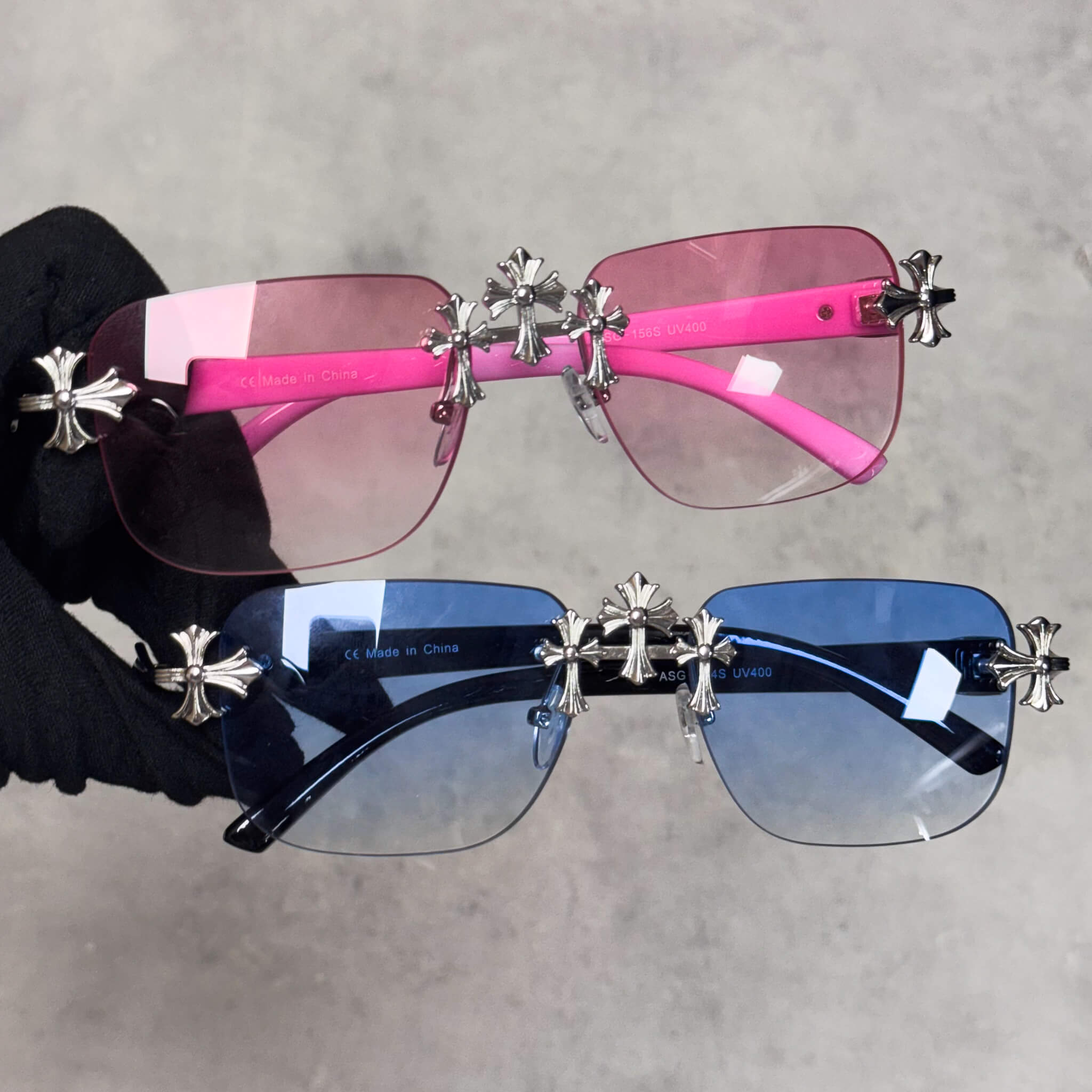 Solid Triple Cross Sunglasses with pink and blue gradient lenses and silver cross accents.