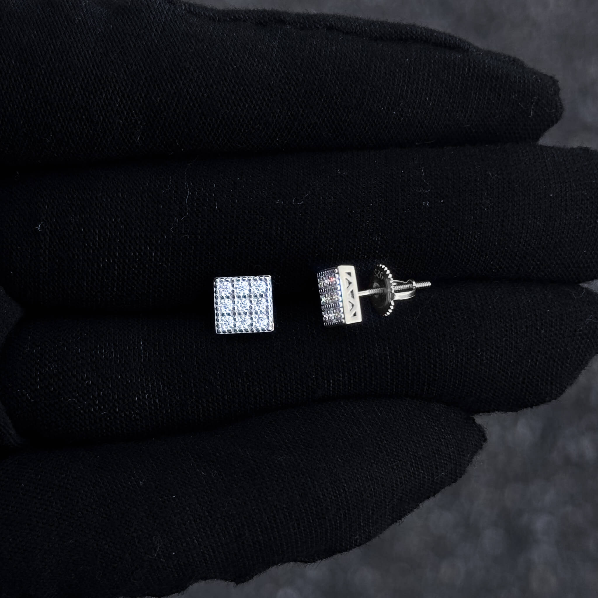 Close-up of 7mm square moissanite stud and screw-back post in sterling silver setting.