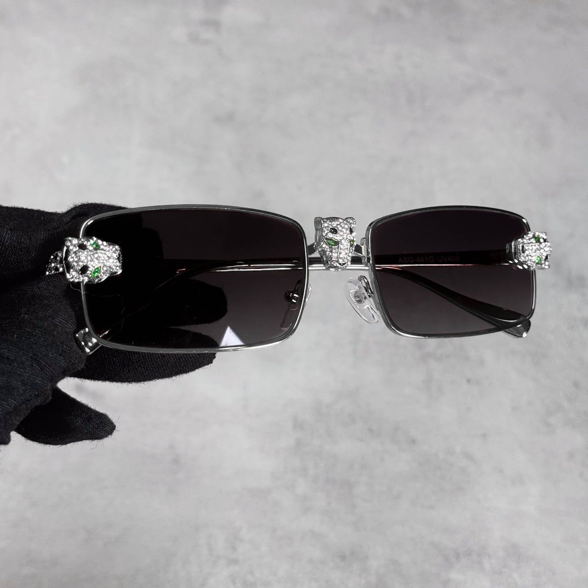 Silver Iced Out Panther Sunglasses with black lenses and crystal panther accents on the frame.
