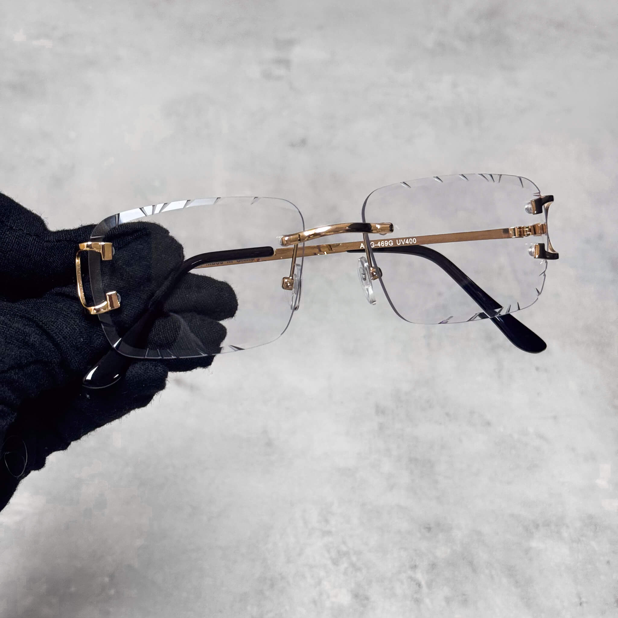 Gold-frame Solid Cut-Edge Sunglasses featuring rimless clear lenses.