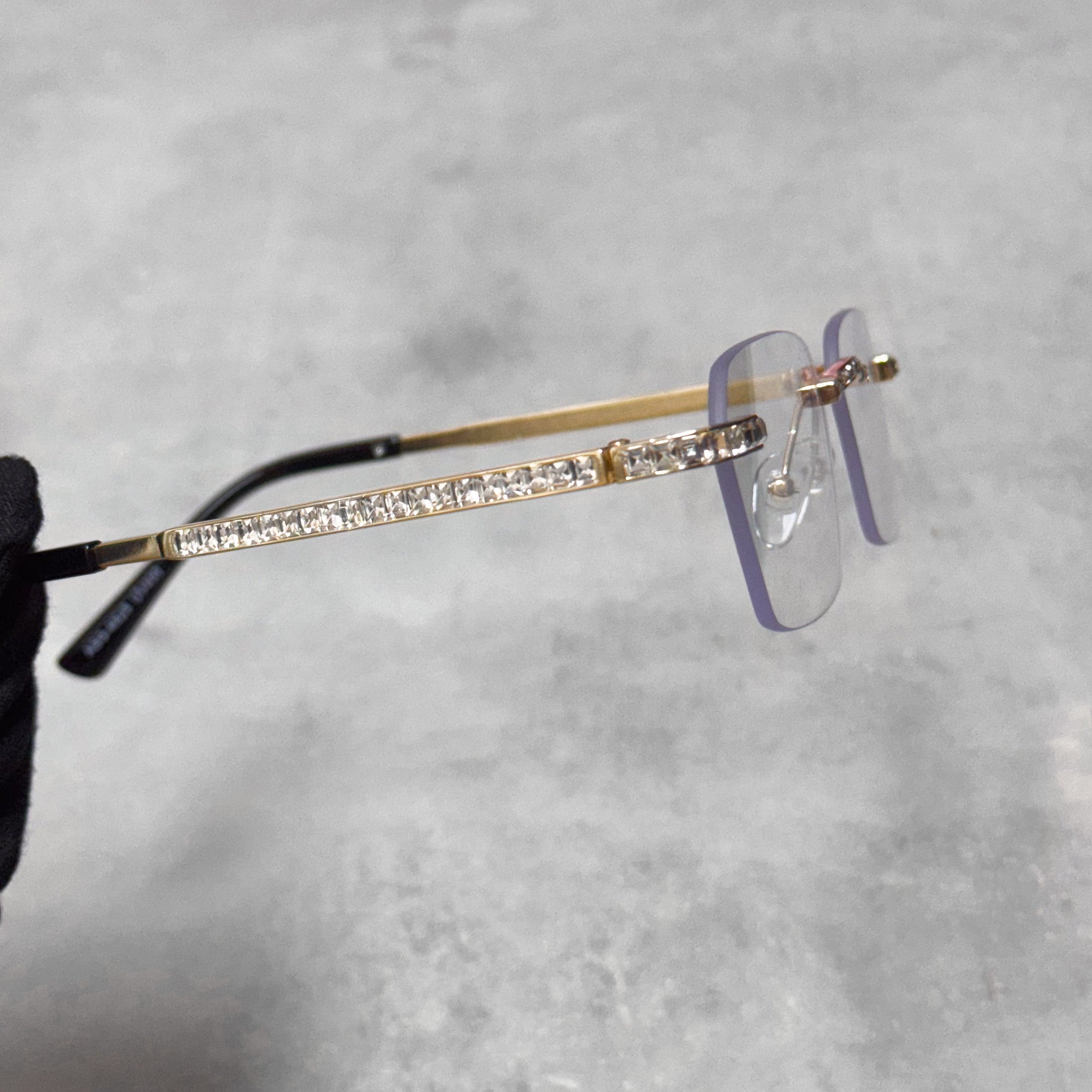Side view of gold clear lens Baguette Stone Sunglasses with full baguette crystal temple.