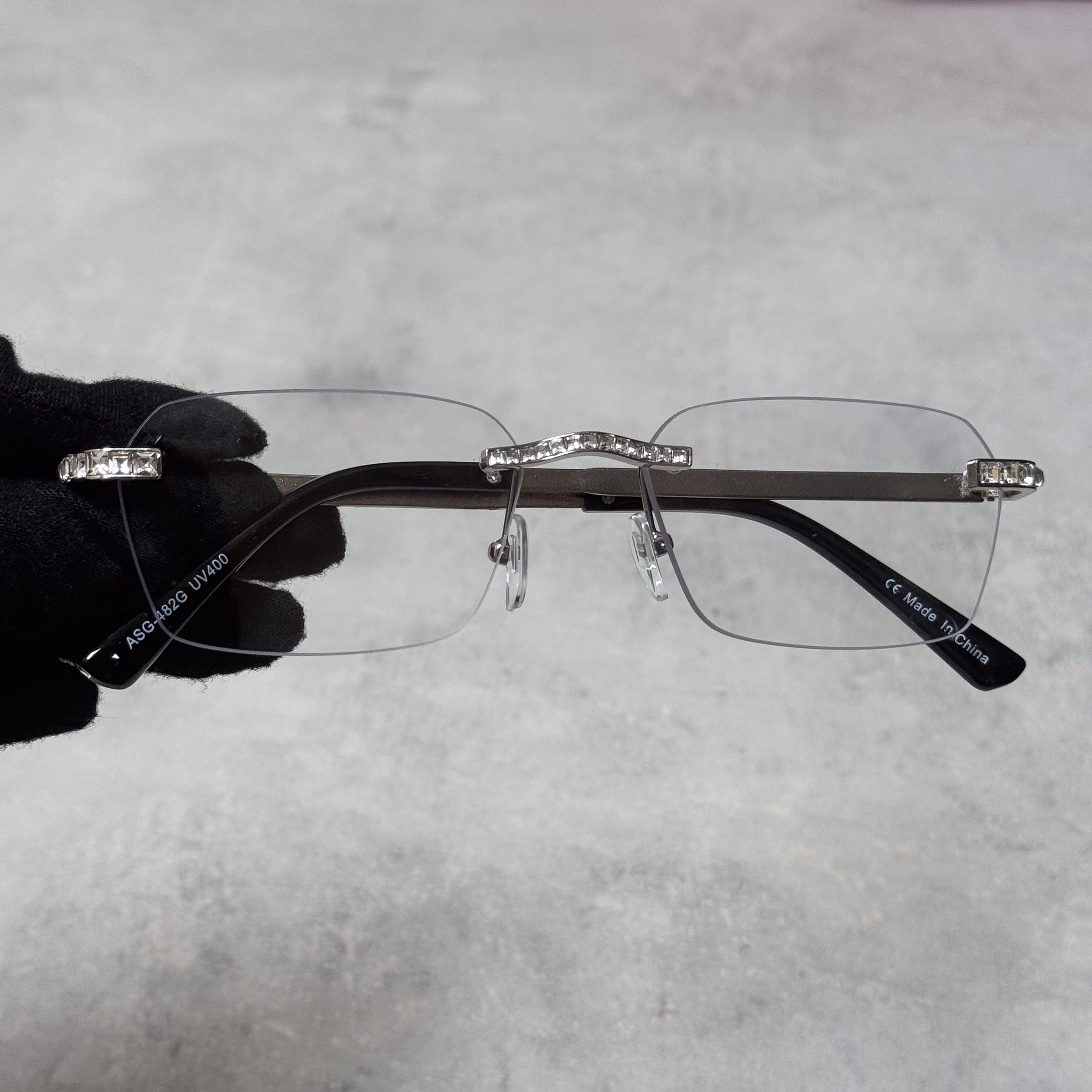 Silver frame clear lens Baguette Stone Sunglasses with rhinestone bridge and rimless design.