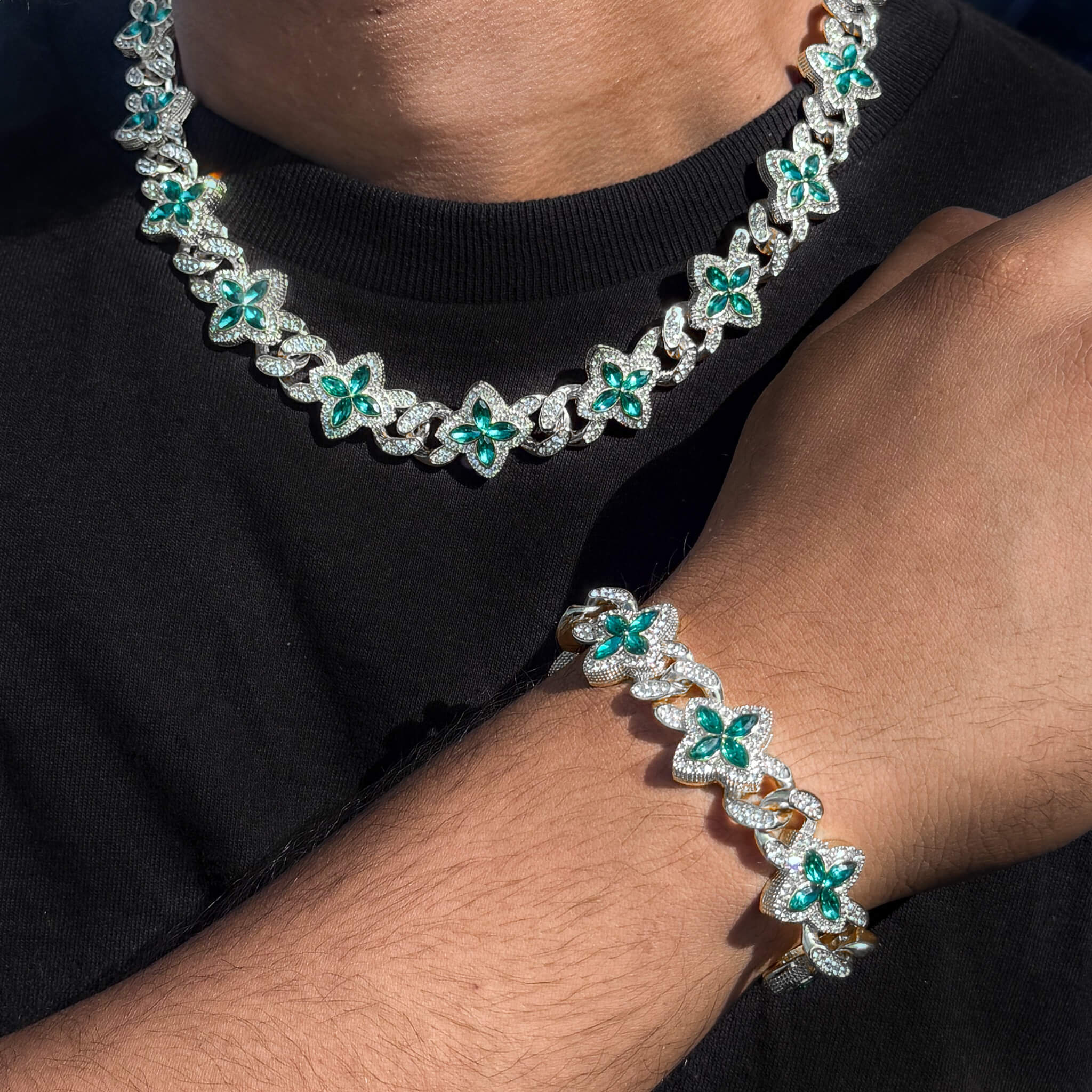 Silver 2-piece iced clover necklace and bracelet set with sparkling Green stones and clover links.