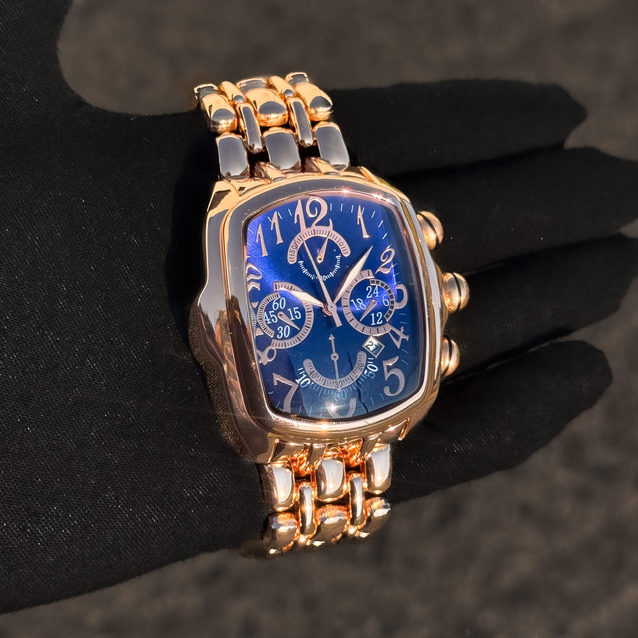 Men’s 43mm Tonneau Watch with rose gold metal strap, blue face and detailed multi-subdials.