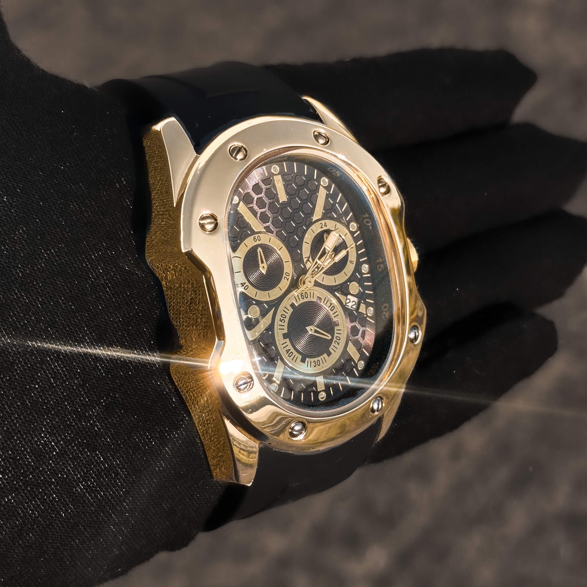 Angled gold Men’s 40mm Classic Watch showing textured black dial and date window.