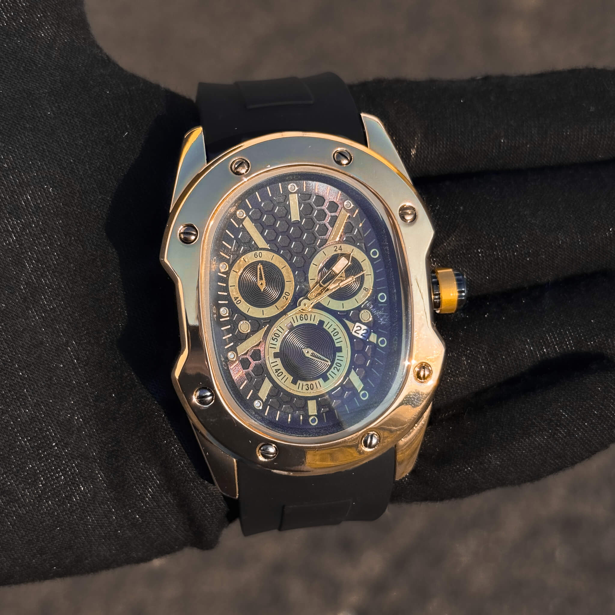 Gold Men’s 40mm Classic Watch with black honeycomb dial and gold chronograph details.