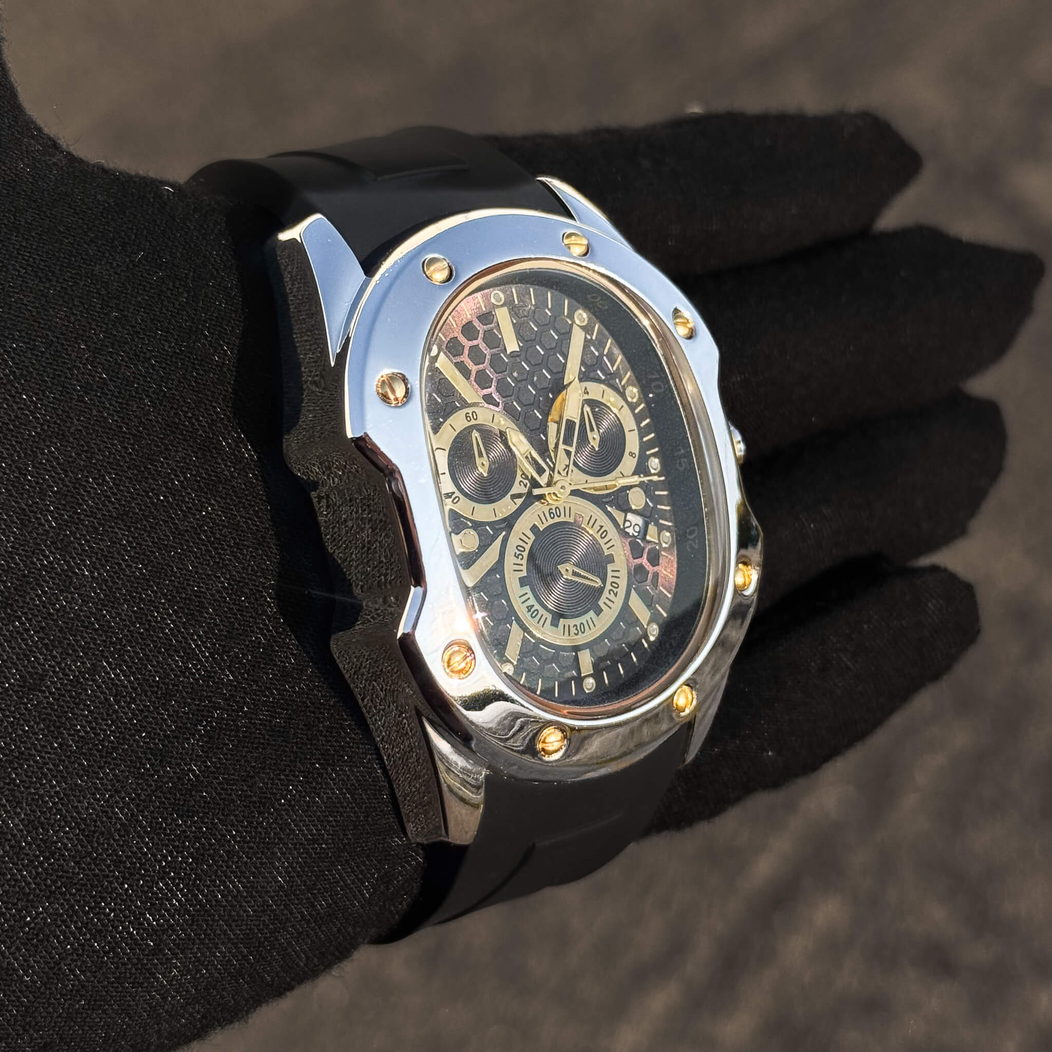 Side view of silver Men’s 40mm Classic Watch with black dial and gold chronograph trim.