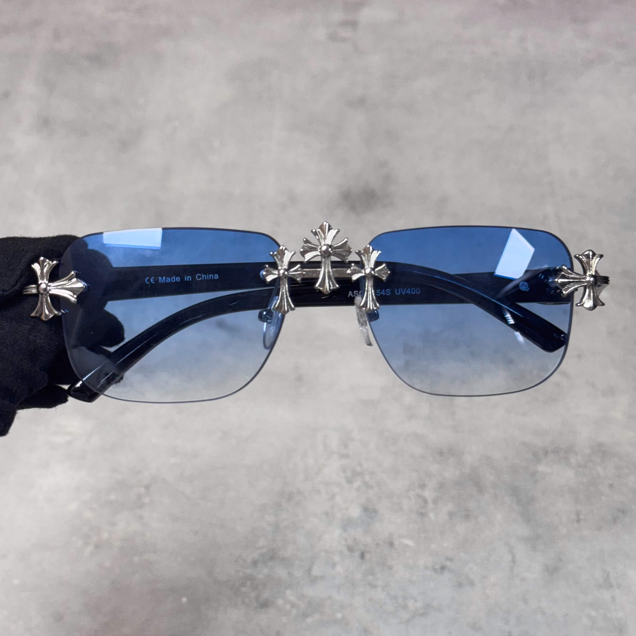 Rimless Solid Triple Cross Sunglasses with blue gradient lenses and silver metal cross design.