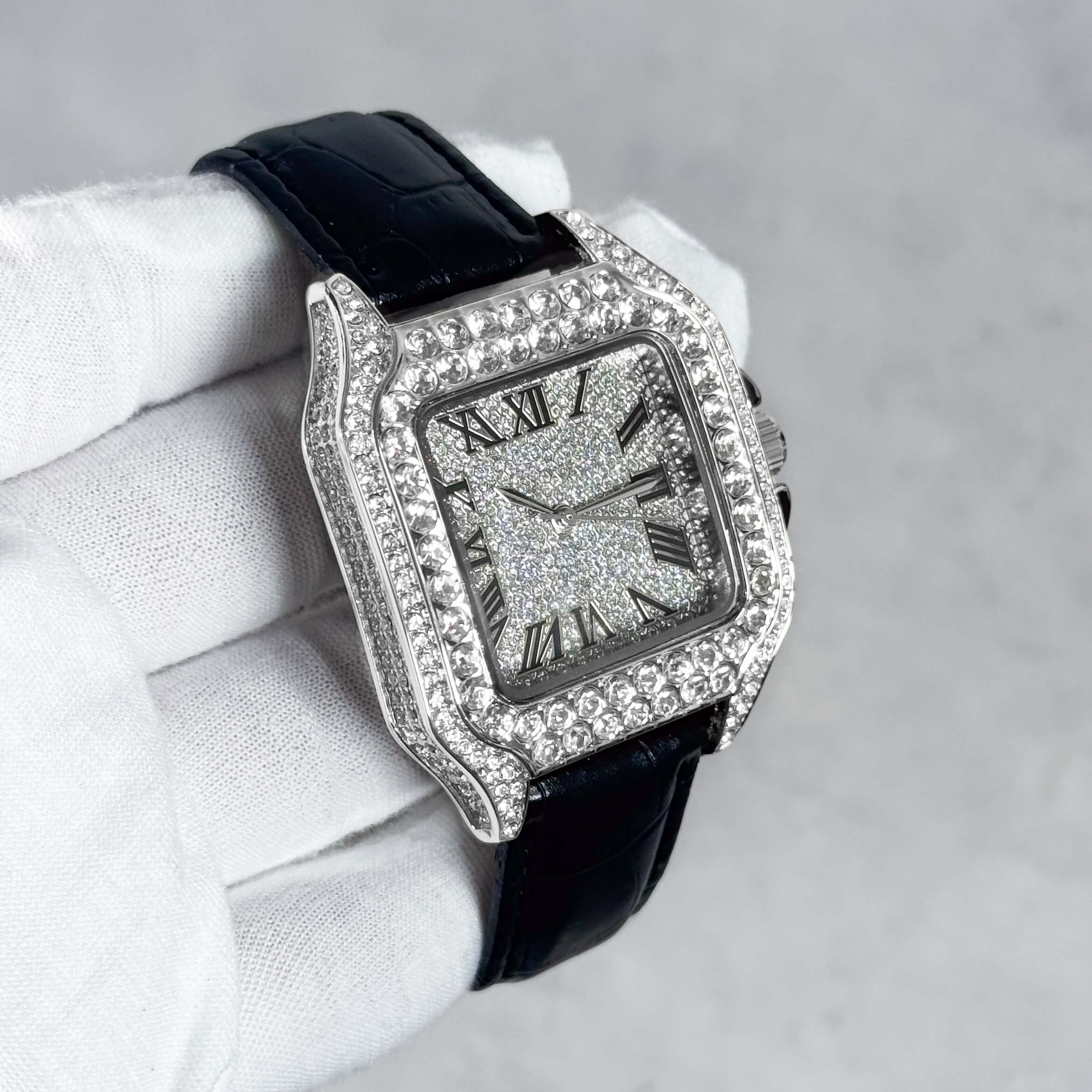 Men's 32mm silver iced out square dial watch displayed at an angle with crystal bezel and strap.
