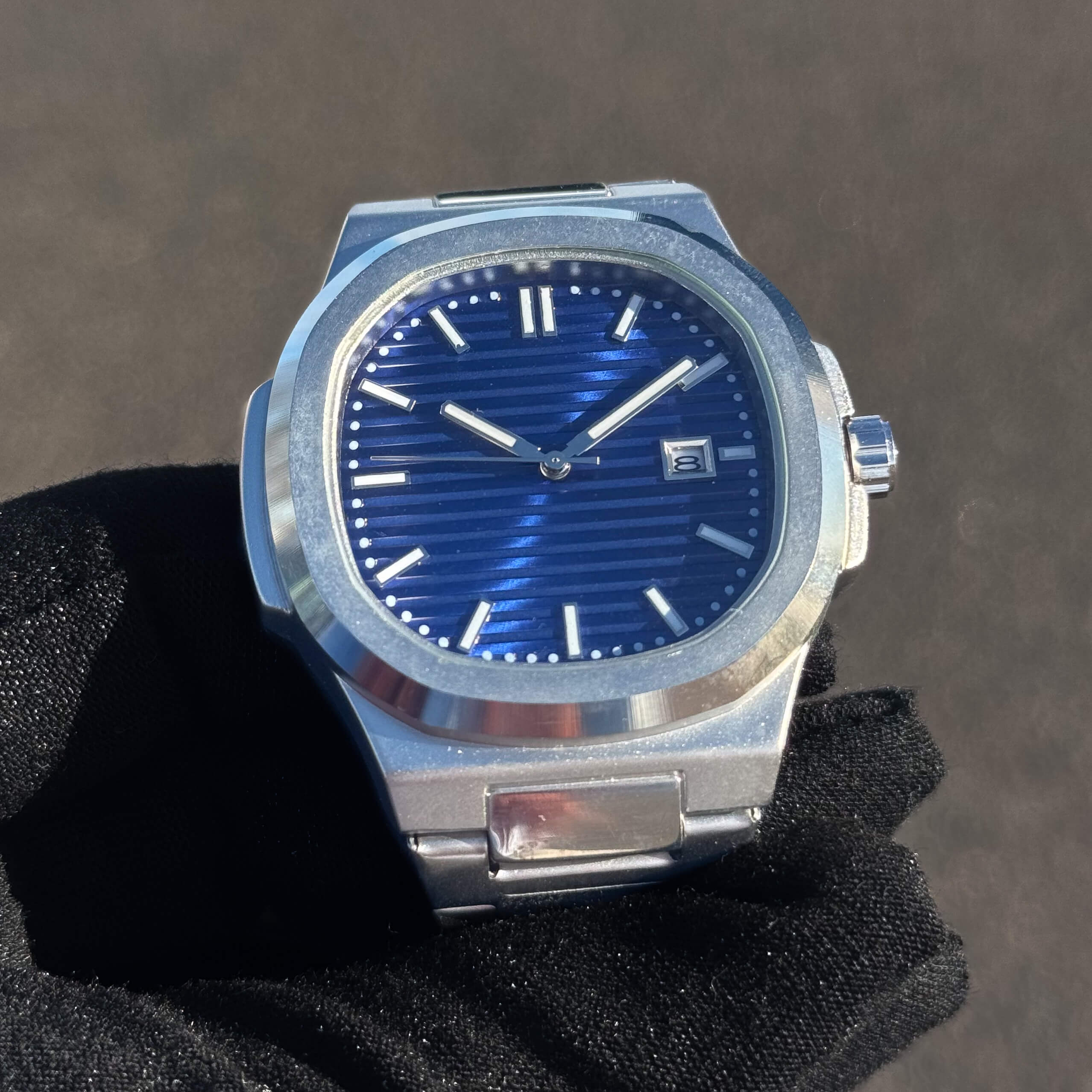 Men’s 42mm Classic Oblong Dial Watch close-up showing blue striped dial and date window.