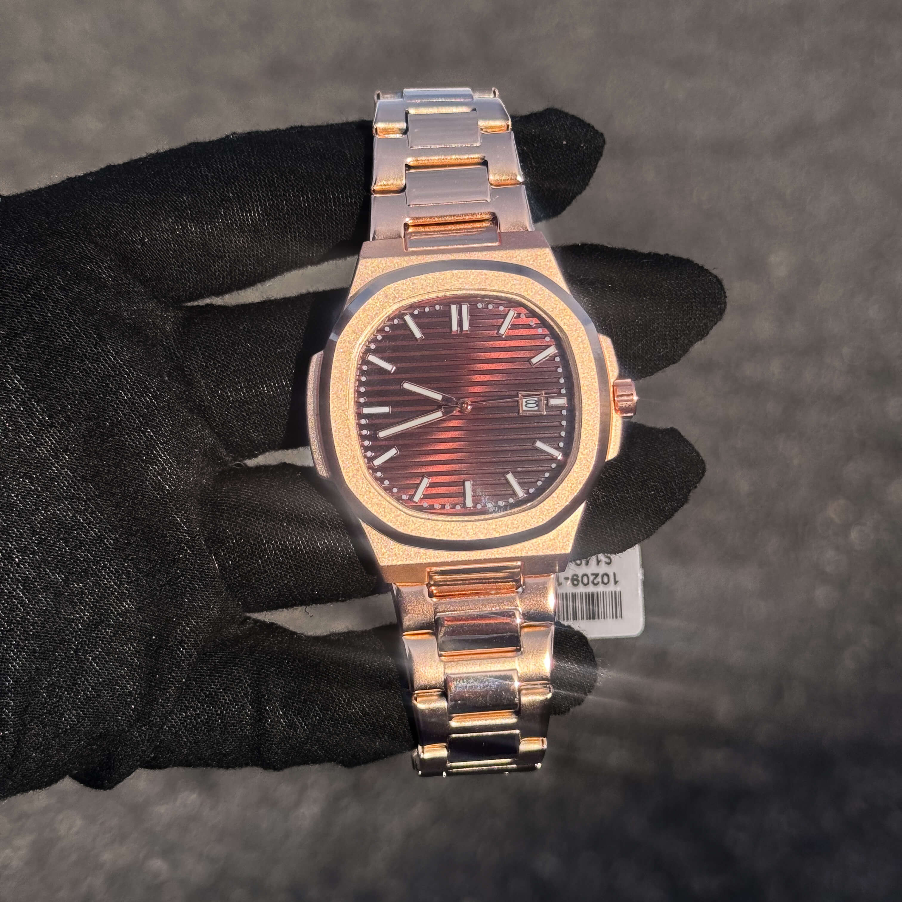 Men’s 42mm Classic Oblong Dial Watch with rose gold textured dial and stainless steel bracelet.